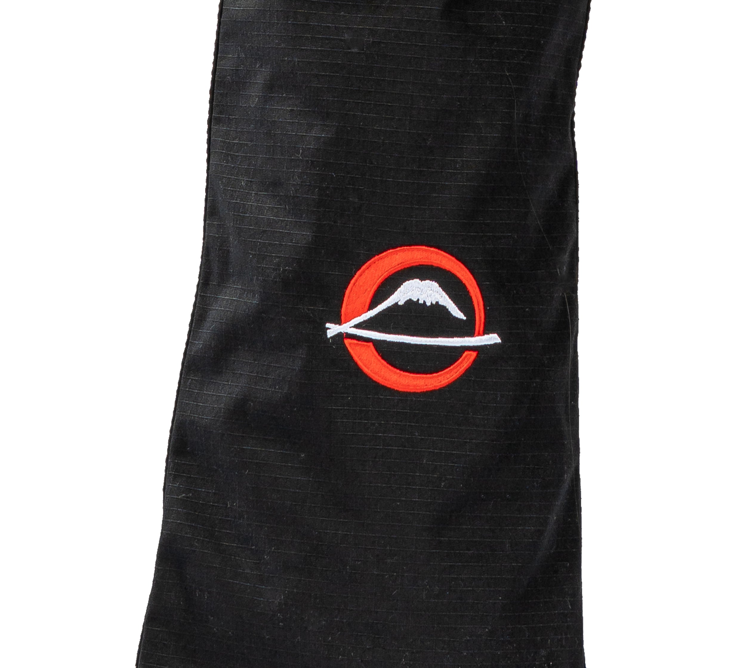 The Suparaito BJJ Gi Worldwide Edition Black features a stitched logo: a white mountain inside a red circle, crossed by a white horizontal line, on black fabric.