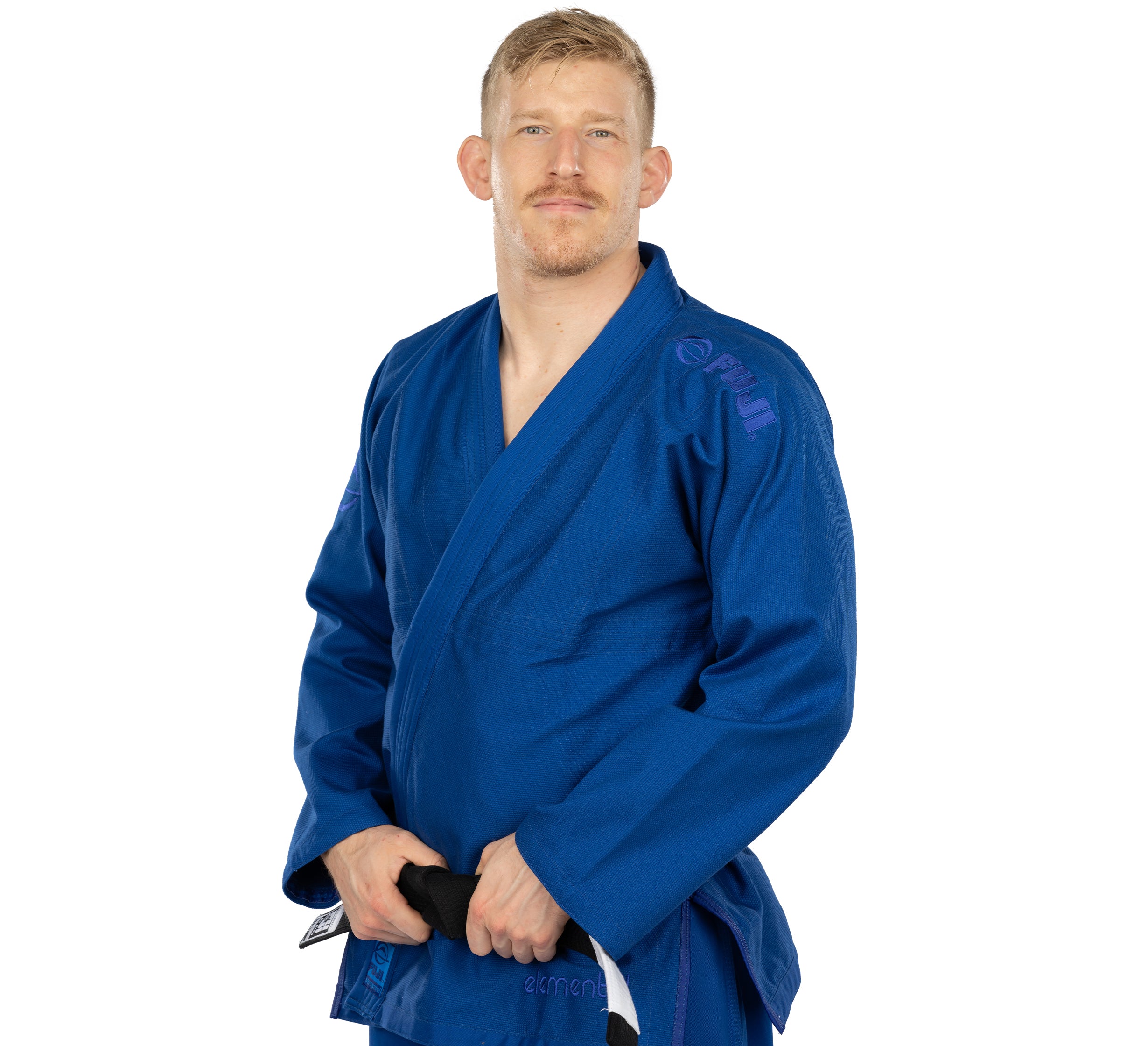 A person wearing the Elemental BJJ Gi Blue stands facing forward, holding a black belt with both hands against a white background.