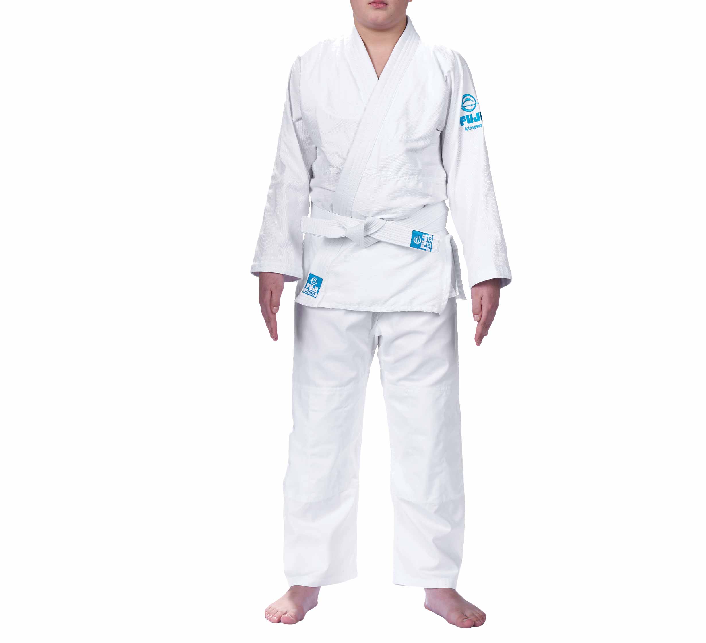 A person stands barefoot against a white background, wearing the Starter Kids Judo Gi—a white martial arts uniform with a white belt and blue patches on the sleeve and hip.