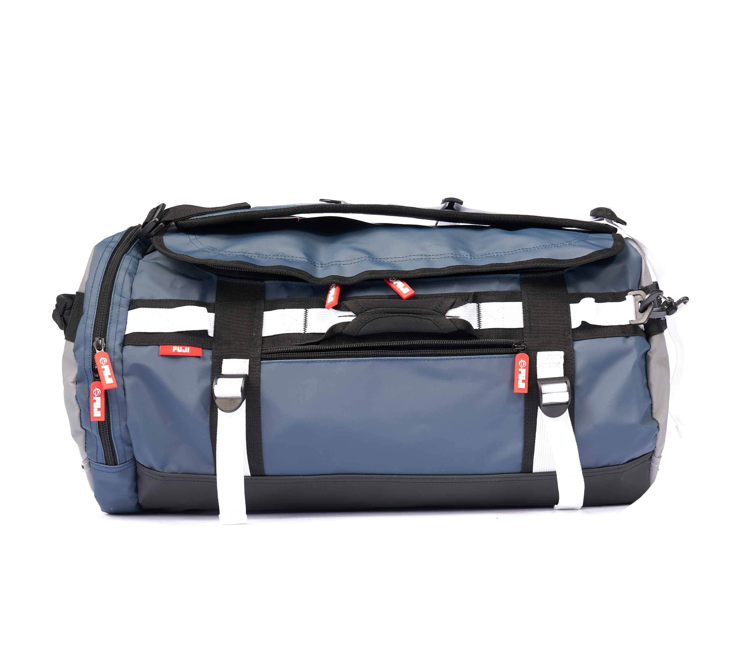 A navy Comp Convertible Backpack Duffle featuring white straps, black accents, and red zipper pulls, displayed on a white background.