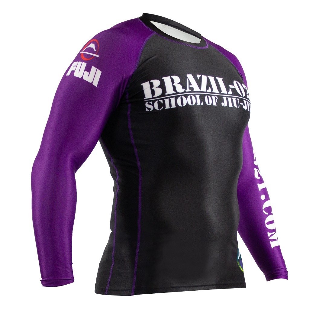 The BRAZIL 021 Ranked Rashguard features purple long sleeves, a black torso, Brazil-021 School of Jiu-Jitsu text on the chest, and FUJI branding with a logo on the right sleeve.