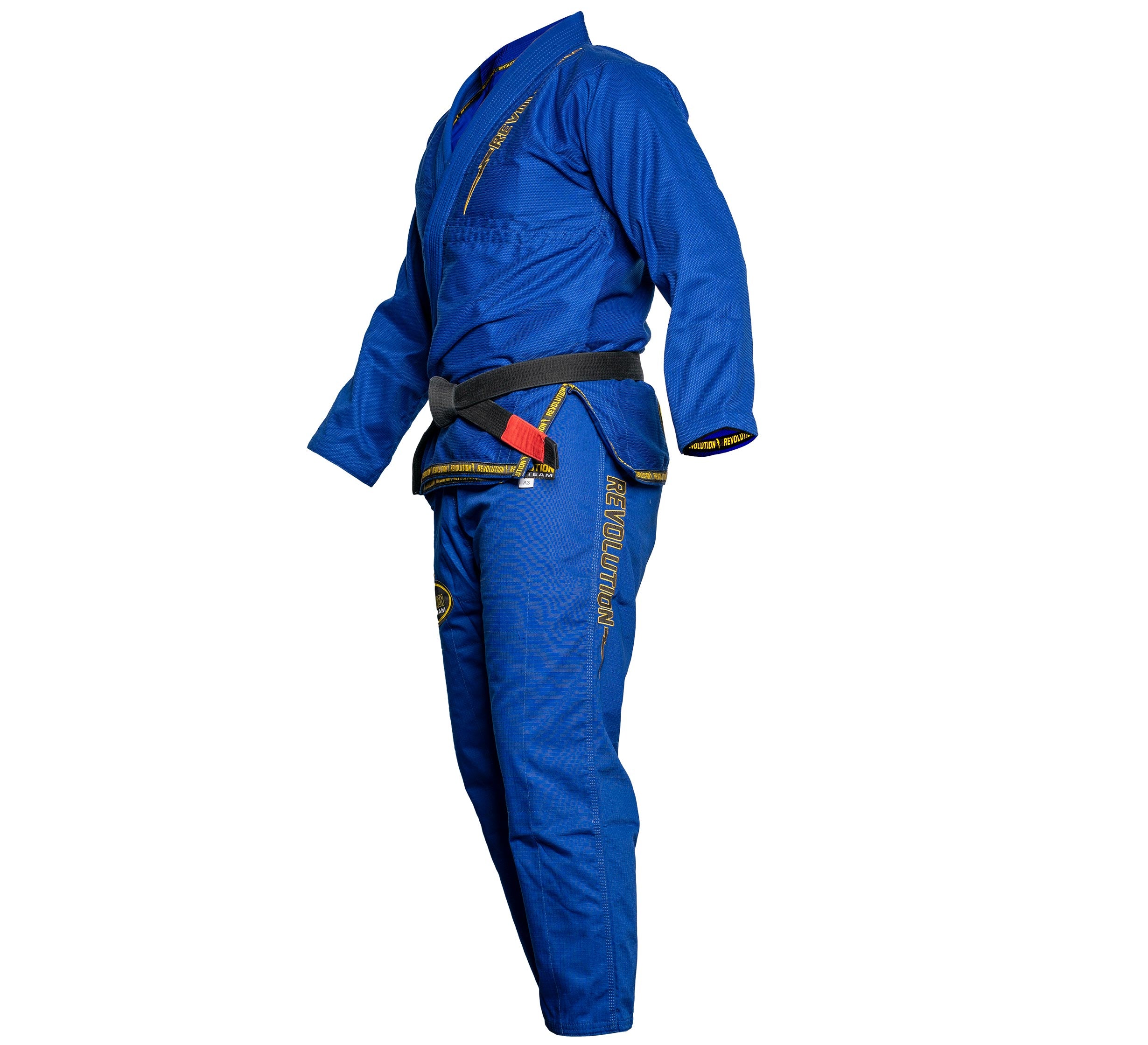 A person in the BJJ Revolution Super Lite Gi (Blue) with yellow embroidery and a black belt stands in side profile against a white background.