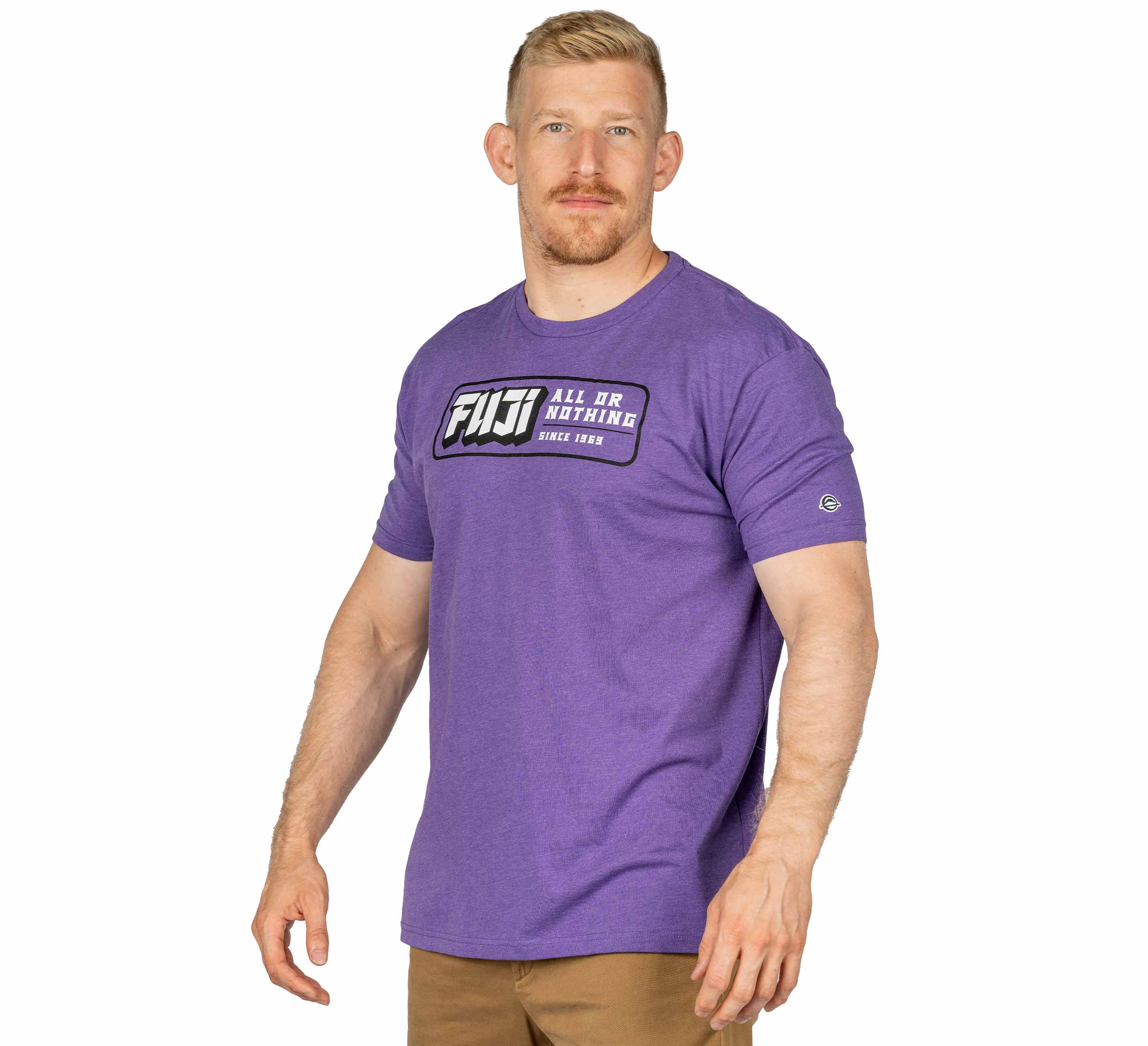 A man with short blond hair, a beard, and mustache wears the Ranked Jiu-Jitsu T-Shirt in purple and tan pants, standing against a white background.
