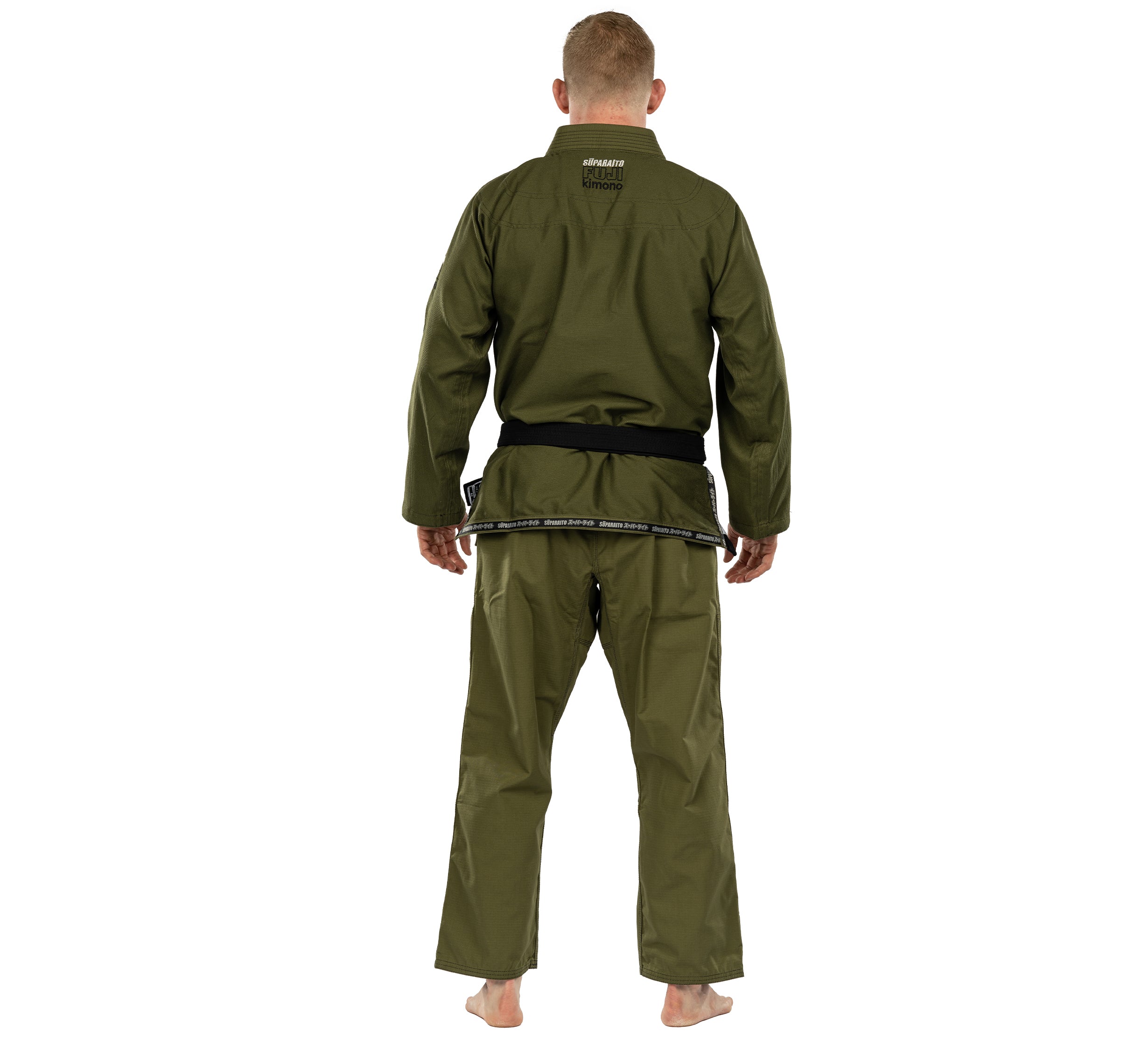 A person stands barefoot facing away, wearing the Suparaito BJJ Gi in olive green with a black belt, set against a white background.