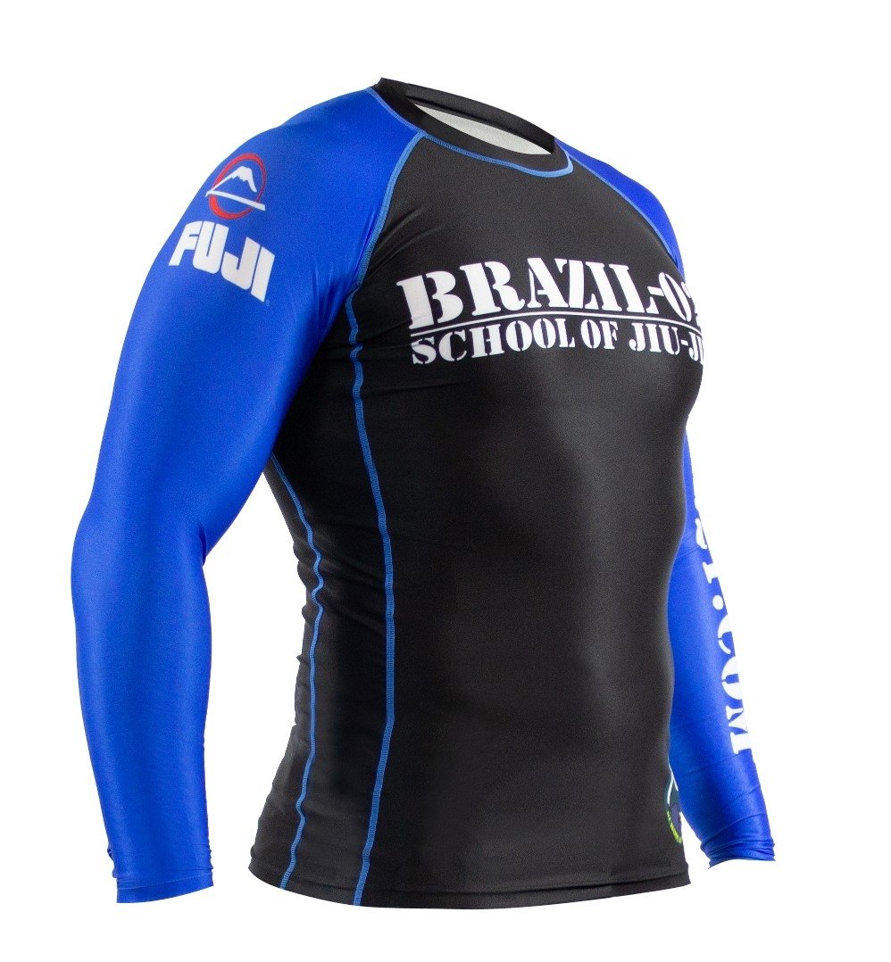 The BRAZIL 021 Ranked Rashguard is a fitted long-sleeve black and blue top featuring "Brazilian School of Jiu-Jitsu" text on the chest and a Fuji logo on the right shoulder, designed for sports or martial arts.