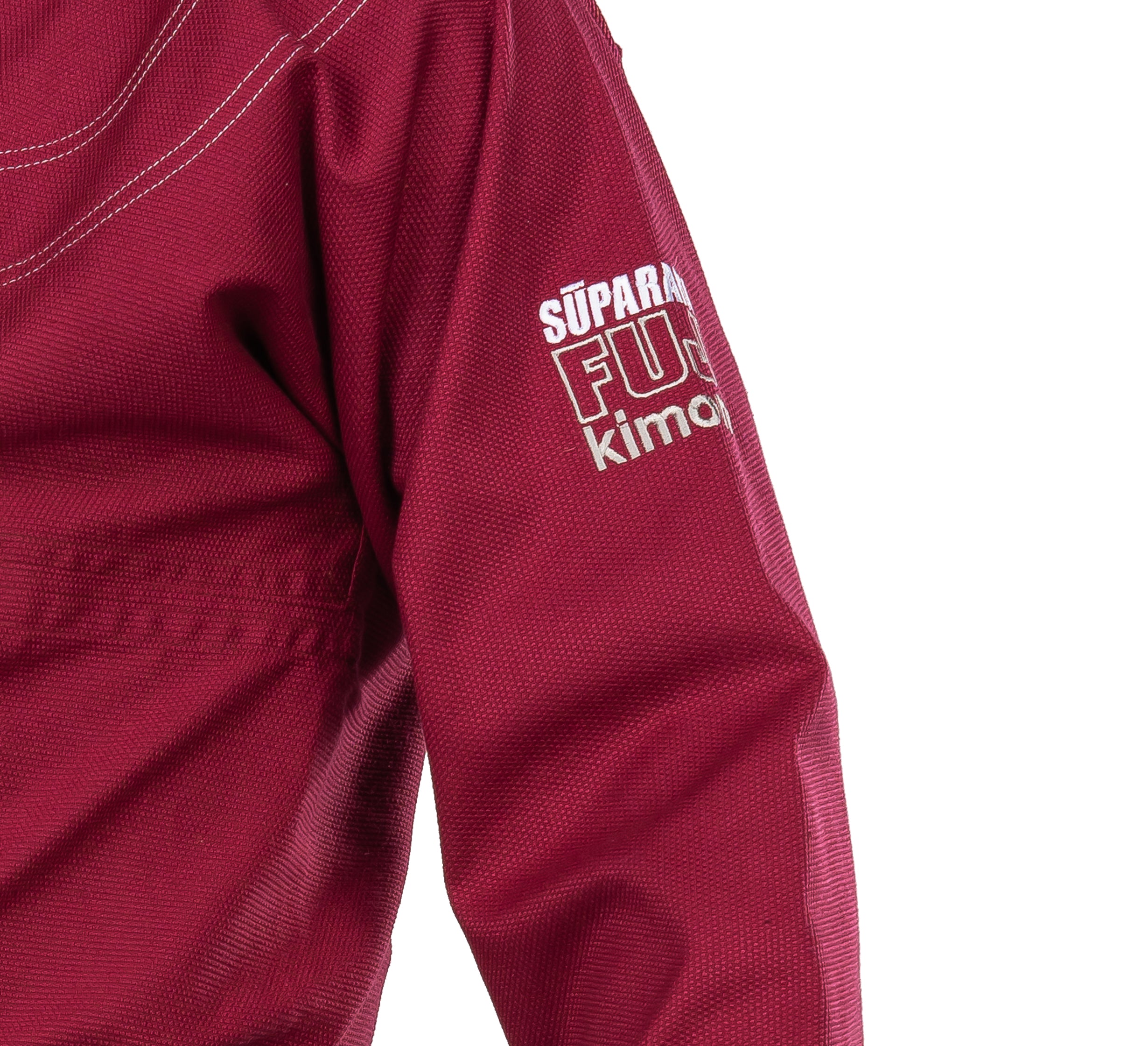 A close-up of the Suparaito BJJ Gi Burgundy shows white stitching and "SÚPARA FUS kim" printed in white on the upper sleeve.
