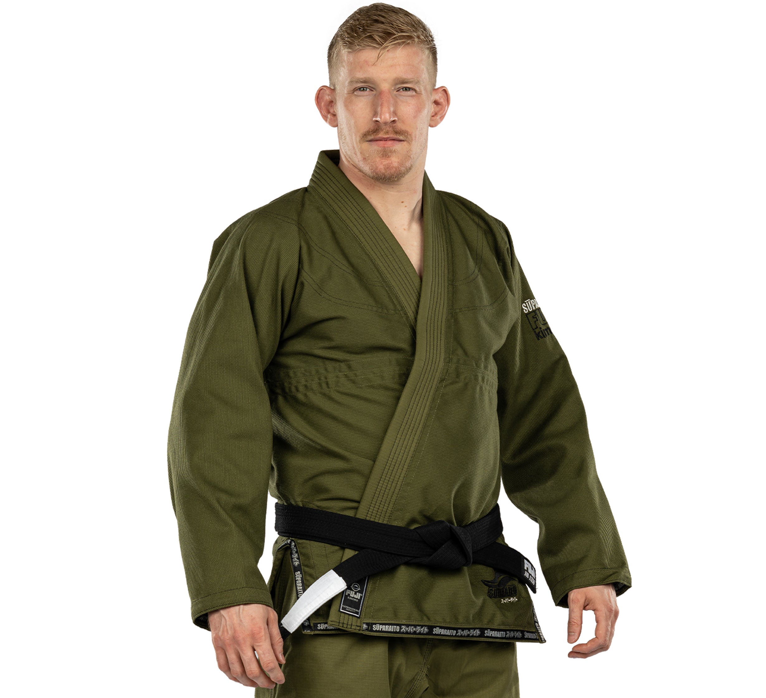 A man with short blond hair and a mustache wears the olive green Suparaito BJJ Gi and a black belt, standing against a plain white background while looking directly at the camera.