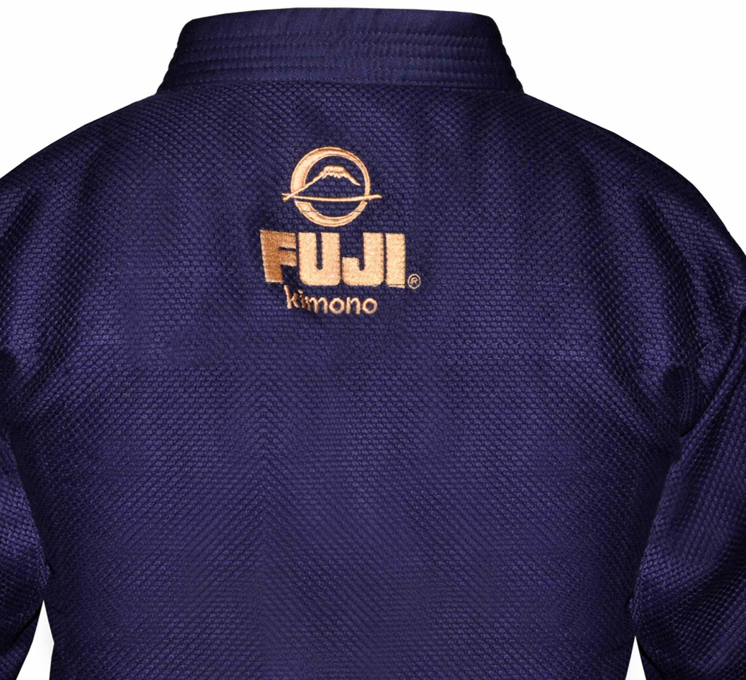 Close-up of the back of a dark blue All Around Kids BJJ Gi featuring gold embroidery with the FUJI logo, a mountain symbol, and the word "Kimono" underneath.