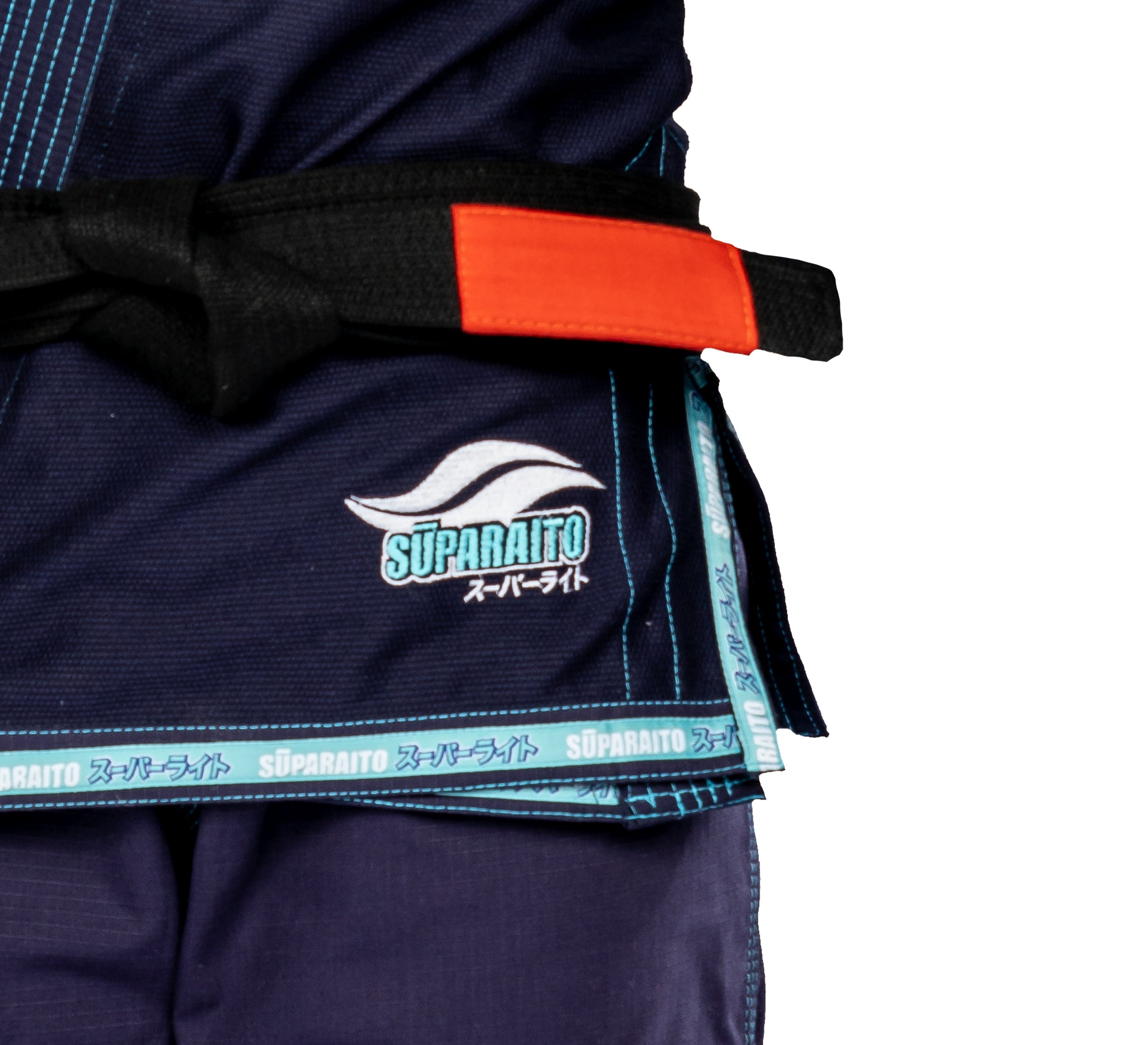 A person wearing the Suparaito Womens BJJ Gi Navy, featuring navy fabric with blue trim, decorative stitching, and SUPARAITO plus Japanese characters embroidered on it. The outfit is accessorized with a black-and-red belt.
