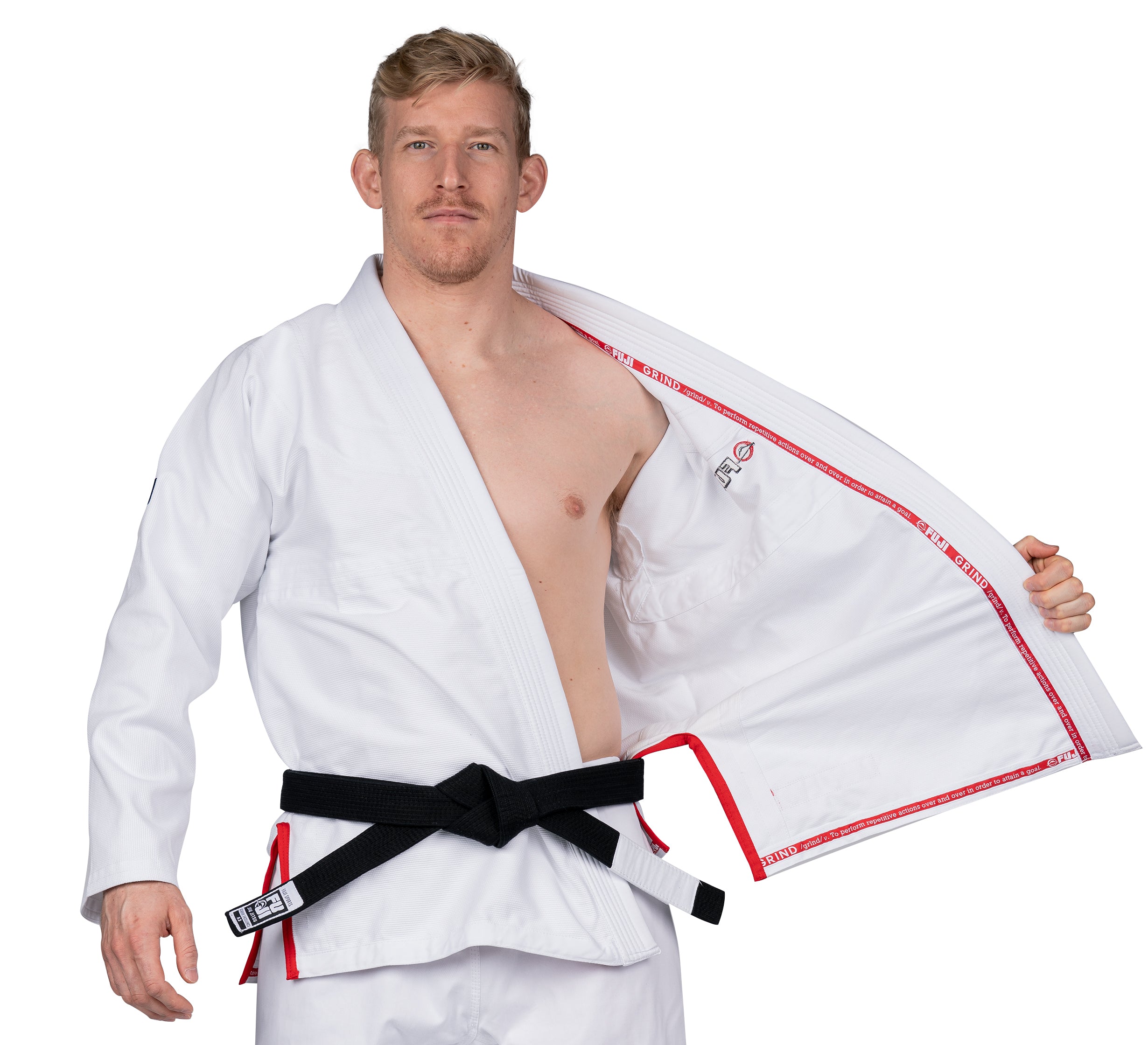 A man confidently models the Elemental BJJ Gi Grind White, opening the front to reveal the interior, against a plain white background.