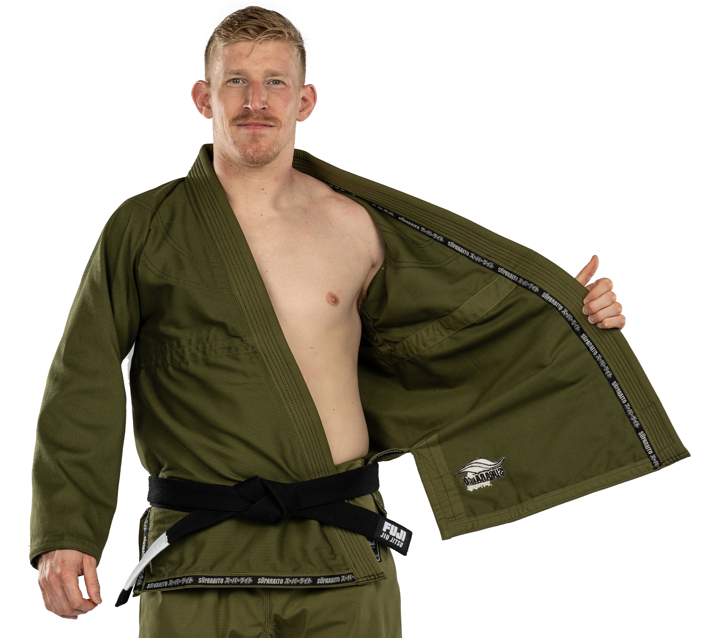 A man wearing the Suparaito BJJ Gi in olive green with a black belt stands facing forward, holding open one side to reveal the interior lining and an inside pocket.