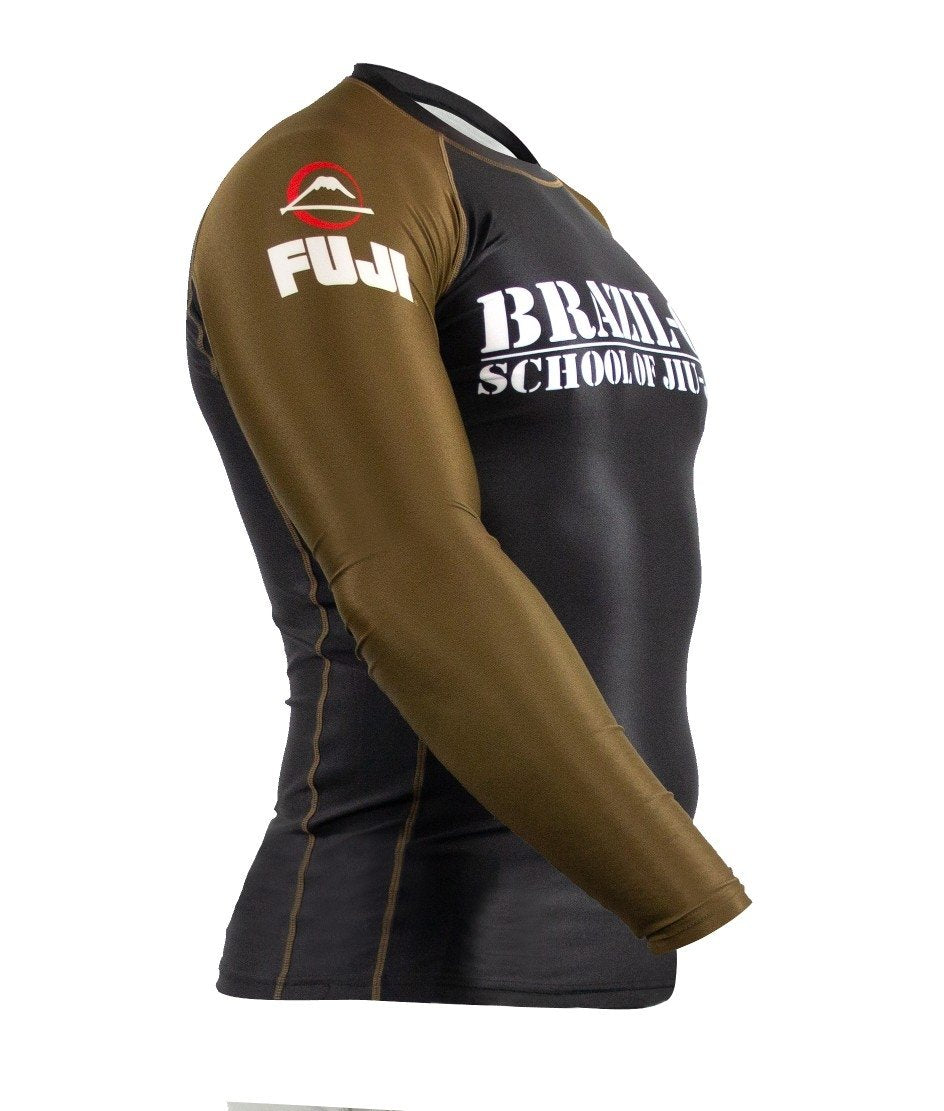 The BRAZIL 021 Ranked Rashguard is a long-sleeve athletic top with brown sleeves, a black body, "BRAZILIAN SCHOOL OF JIU JITSU" on the chest, and FUJI’s mountain logo on the left shoulder.