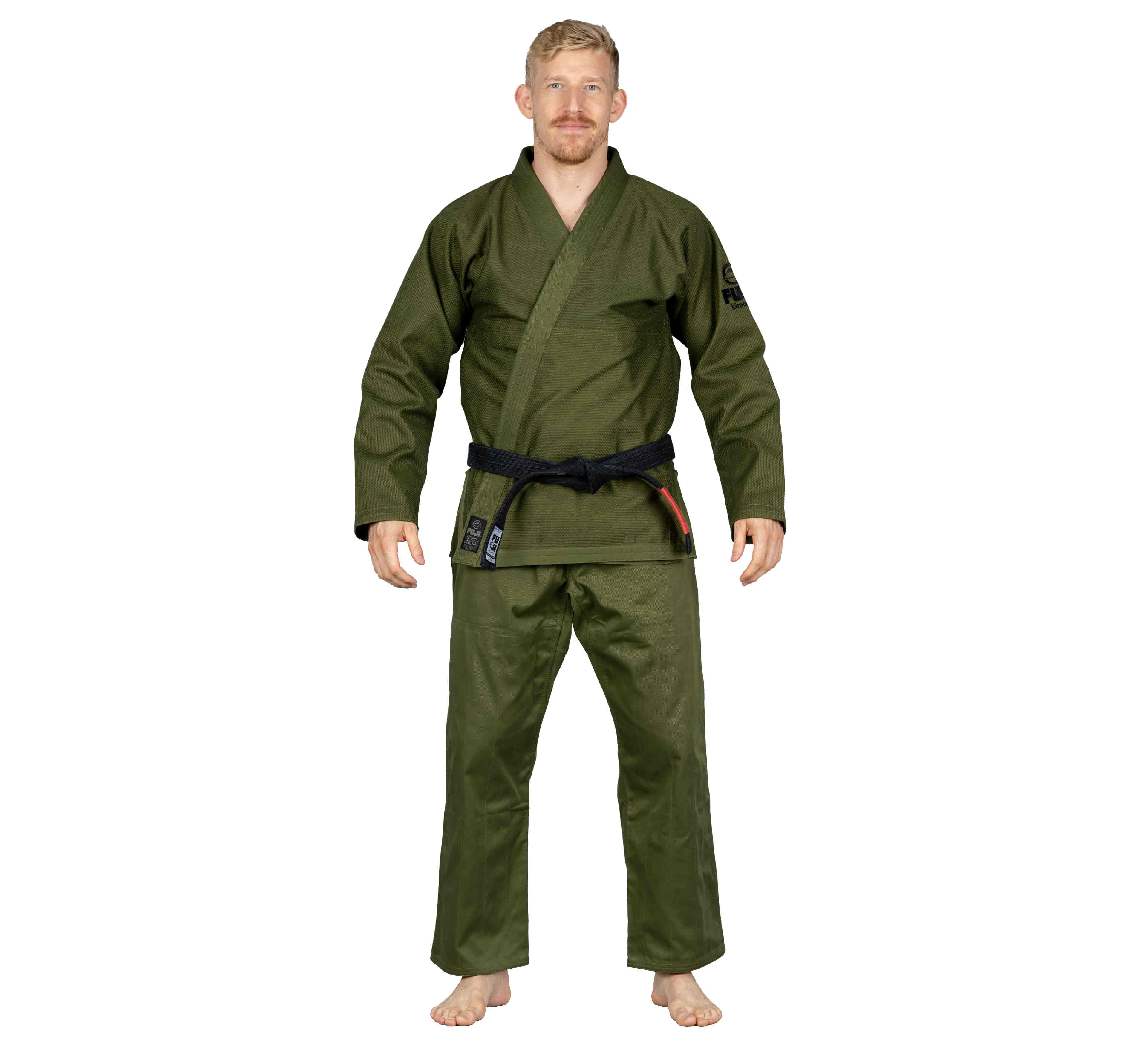 A man stands barefoot, wearing the All Around BJJ Gi Military Green and a black belt, facing forward with a neutral expression against a plain white background.