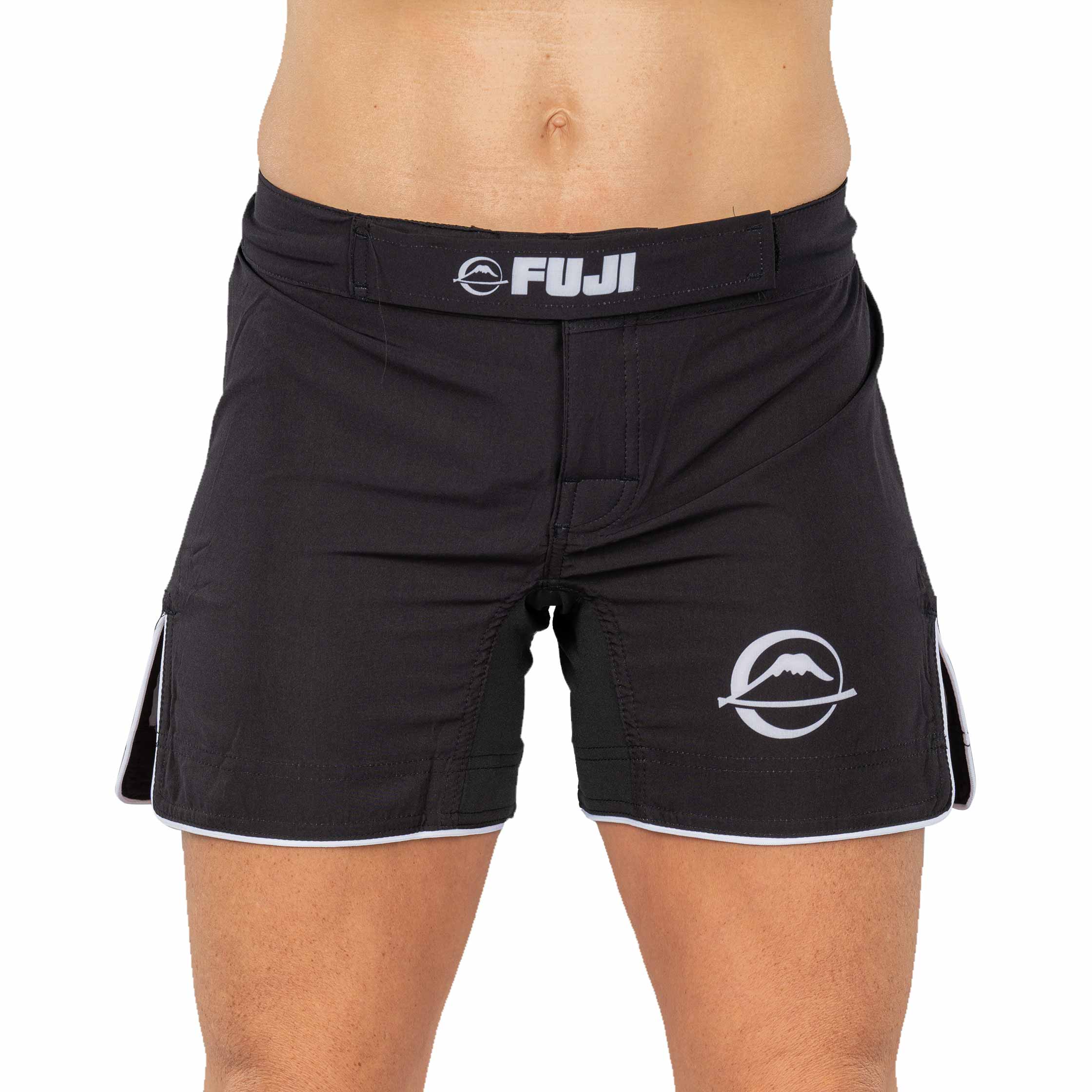 A person wearing Baseline Womens Black Grappling Shorts with a white mountain logo on the left leg, photographed from waist to mid-thigh against a plain background.