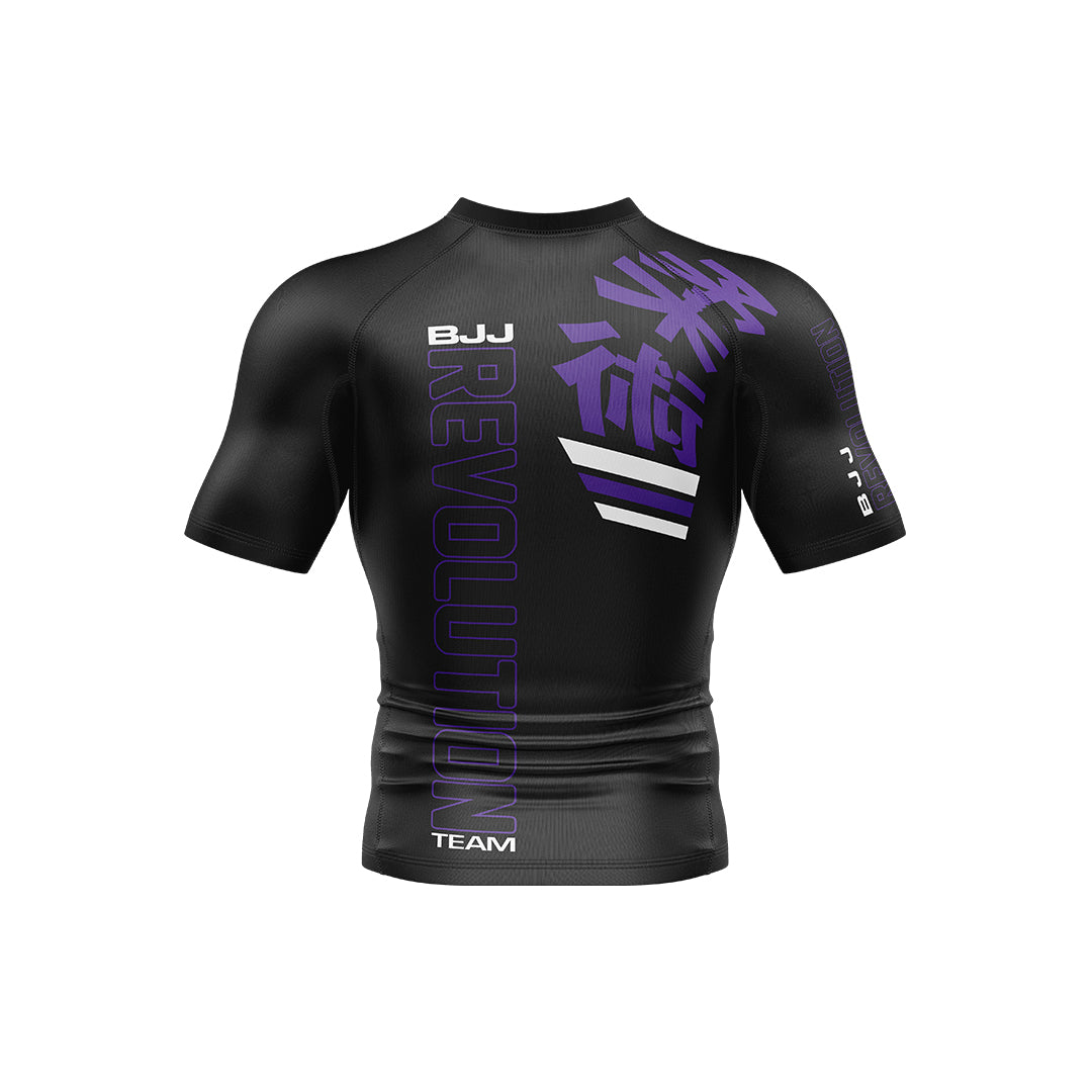 The BJJ Revolution Adult Ranked Short Sleeve Rashguard features a black design with purple "REVOLUTION," white diagonal stripes, and purple Japanese kanji on the upper left chest. "BJJ" and "TEAM" are printed in white.