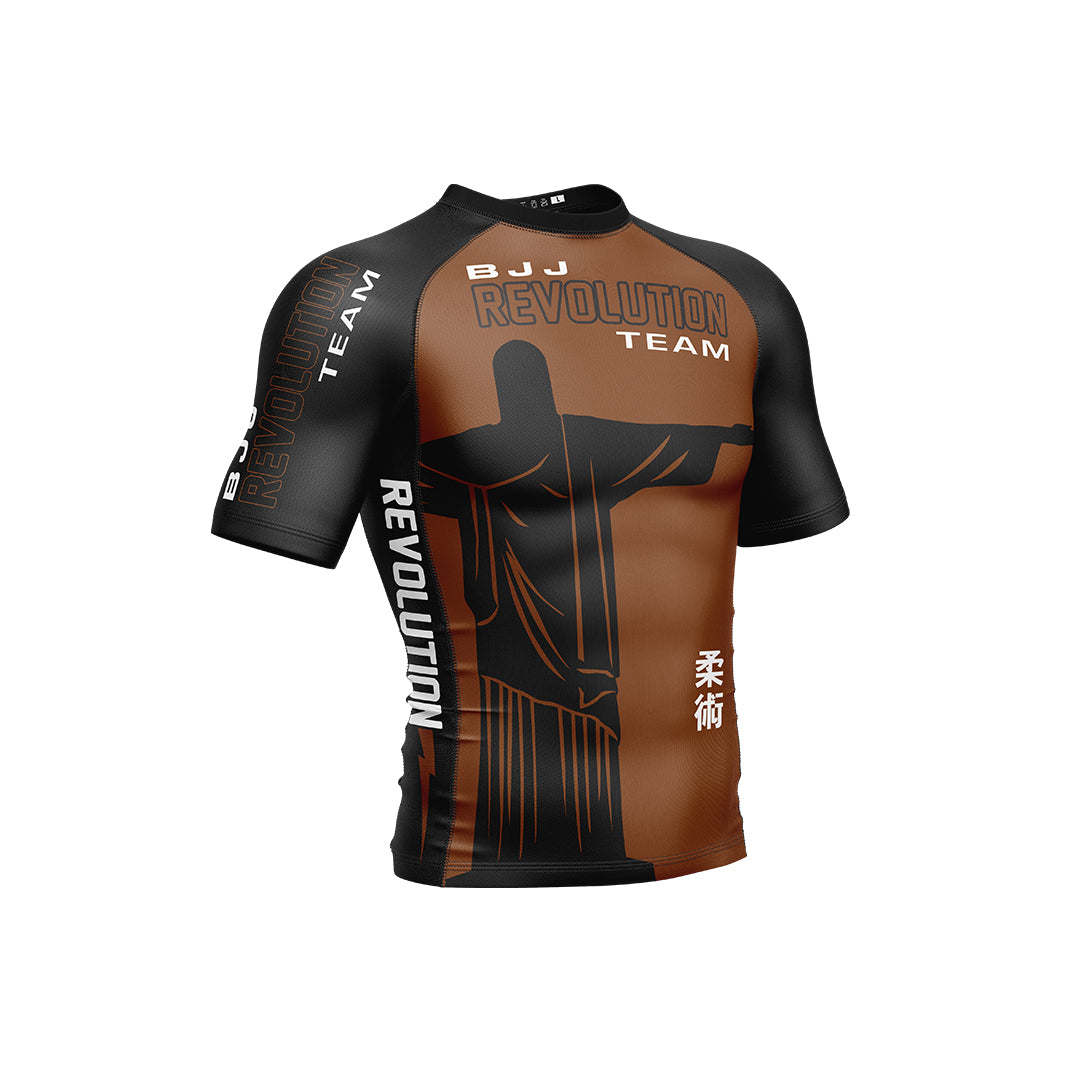 The BJJ Revolution Adult Ranked Short Sleeve Rashguard in brown features a Christ the Redeemer graphic, BJJ Revolution Team text, and Japanese kanji on the front and side.