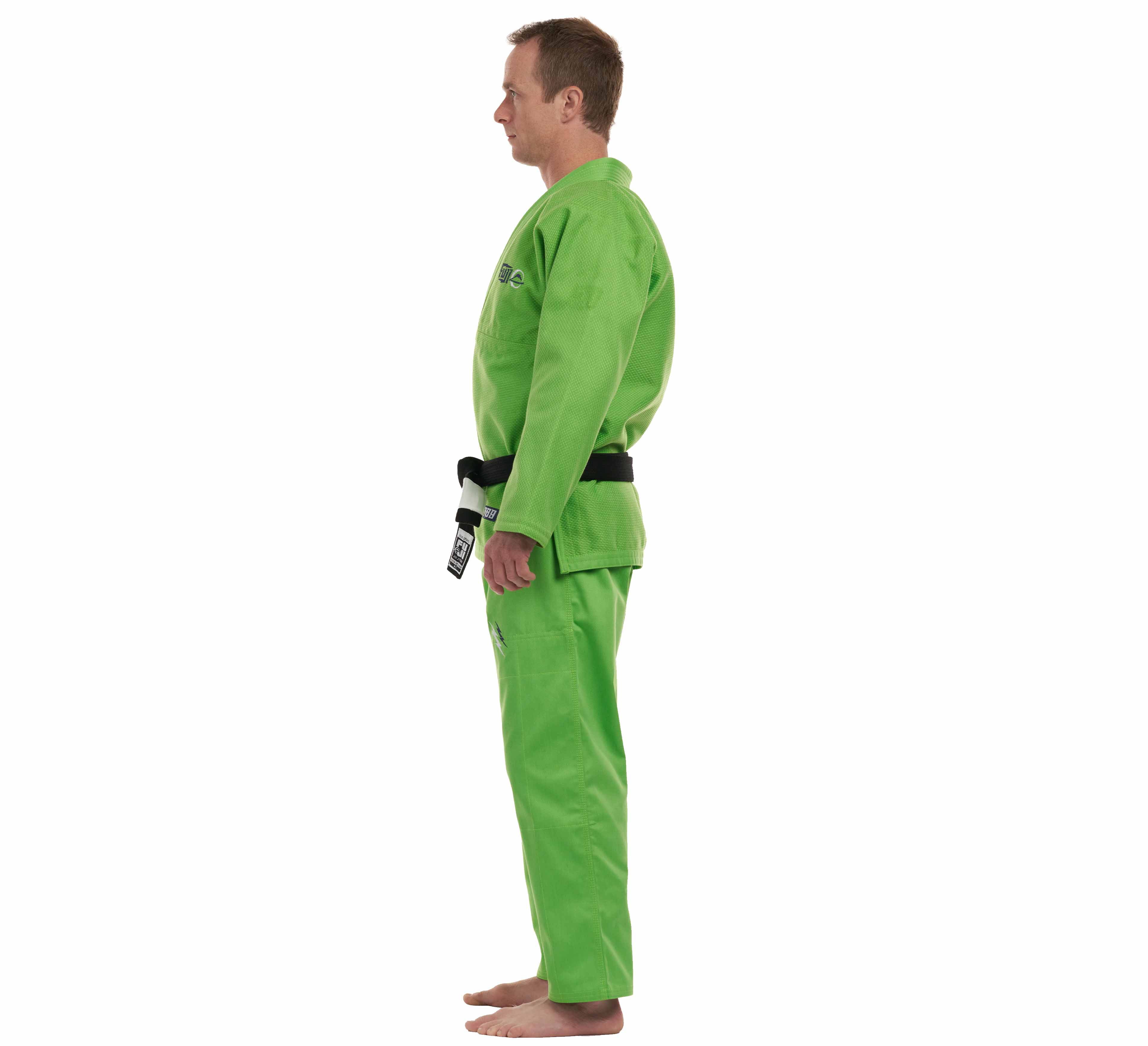 A man stands barefoot in profile, facing left against a white background, wearing the All Around BJJ Gi Electric Green Edition and a black belt.
