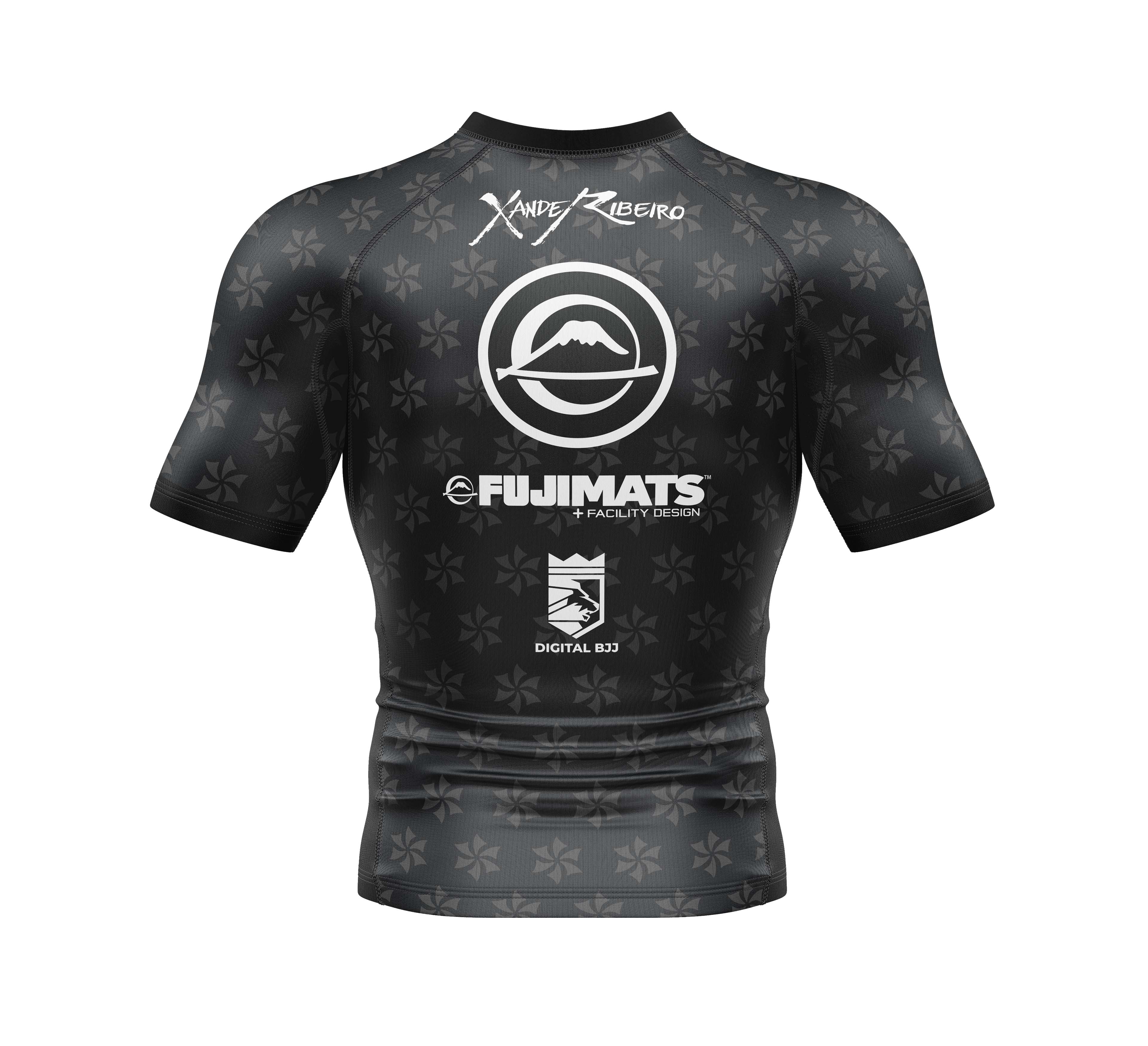 The Xande Comp Short Sleeve Rashguard Black features subtle star patterns, a mountain logo, and sponsor logos like “Xande Ribeiro,” “FUJIMATS,” and “DIGITAL B23” on the back.