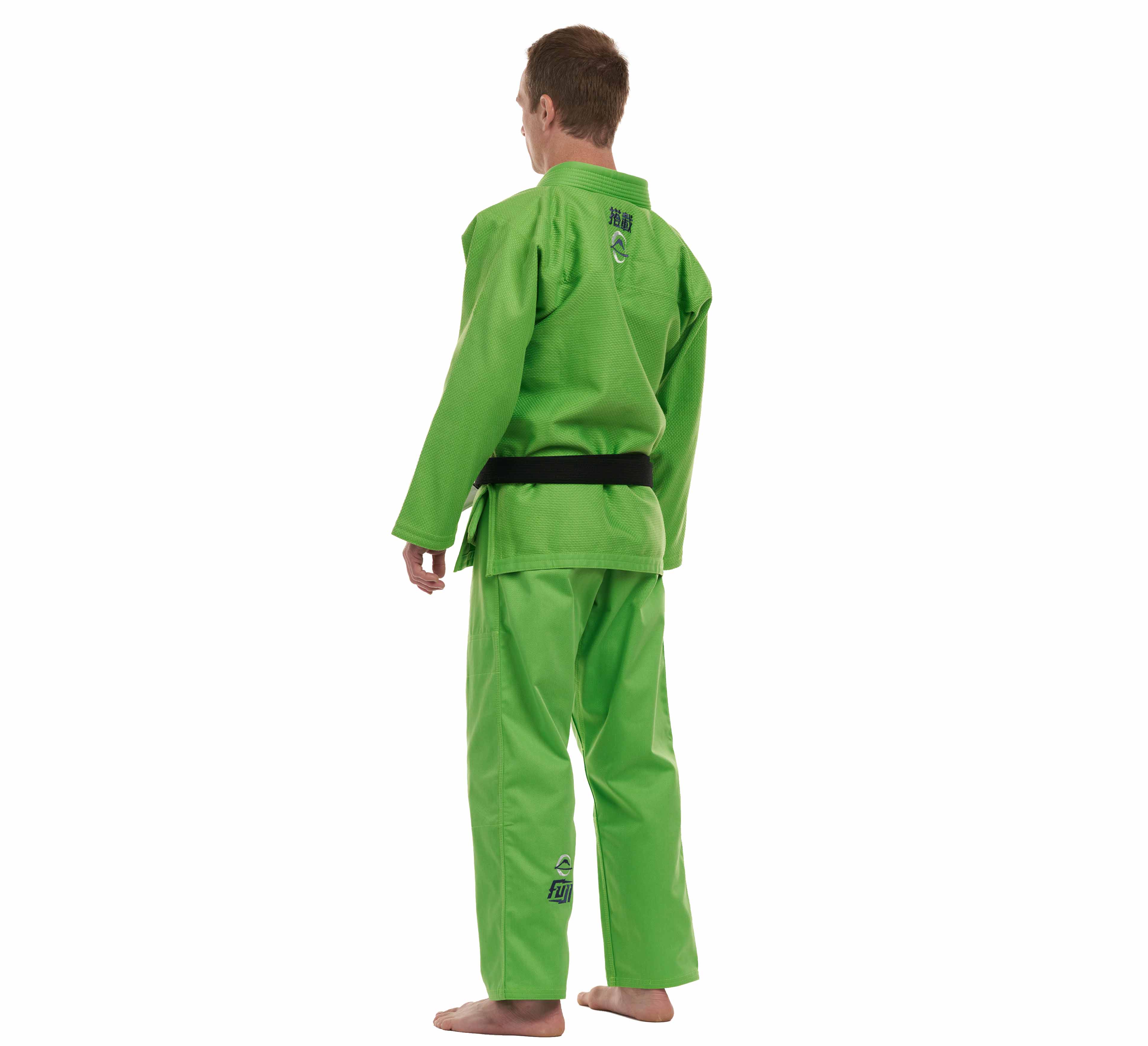 A person wearing the All Around BJJ Gi Electric Green Edition with a black belt stands barefoot, facing away from the camera.