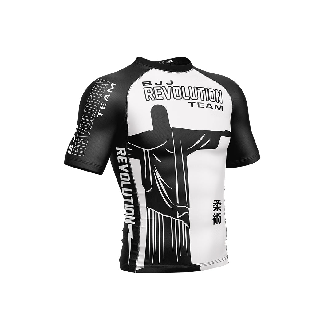 The BJJ Revolution Adult Ranked Short Sleeve Rashguard in white features bold REVOLUTION TEAM text and a Christ the Redeemer statue design on the chest, sleeves, and sides.