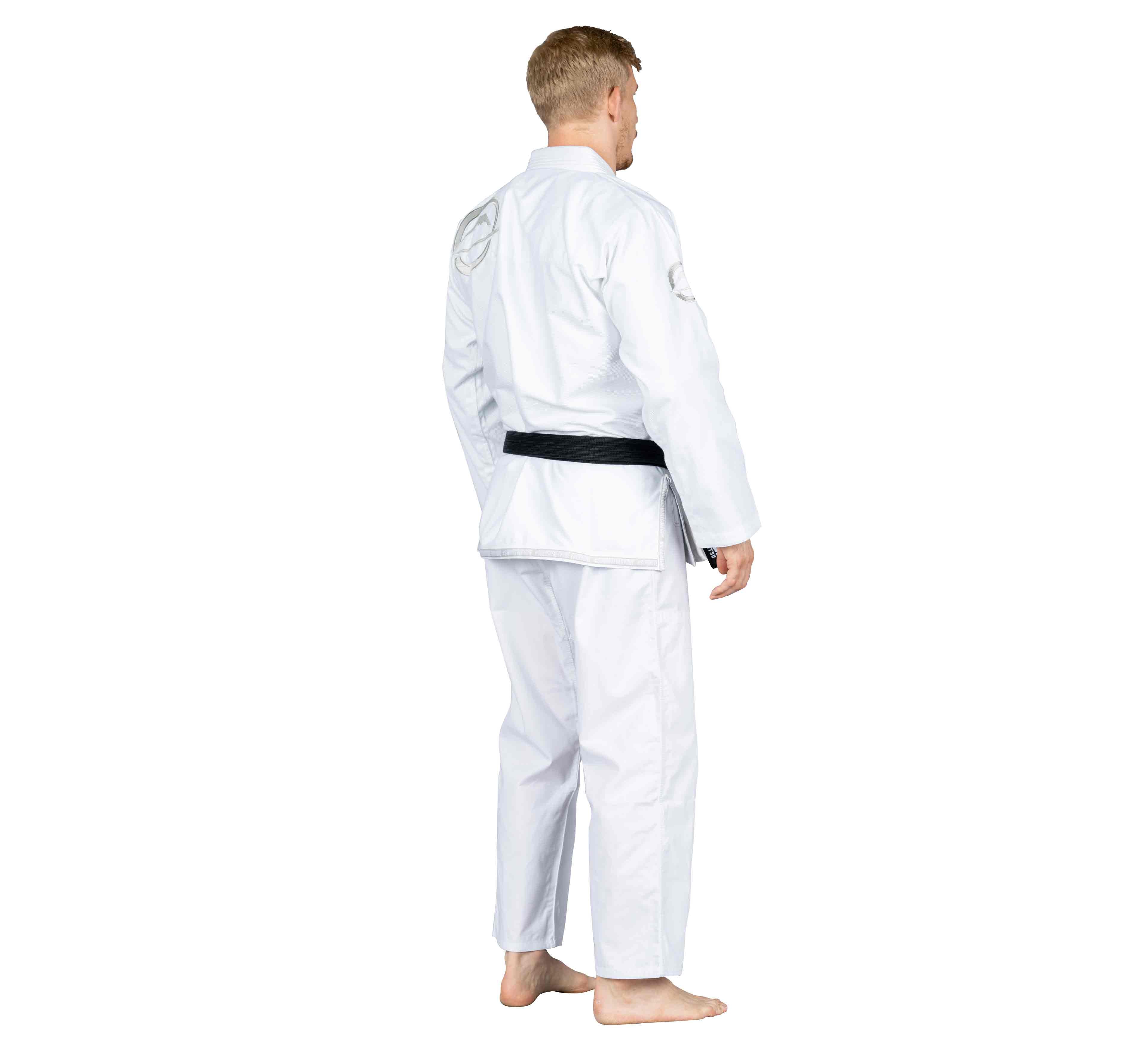 A person in a Suparaito BJJ Gi Submit Everyone Ice White with a black belt stands barefoot, angled away, against a plain white background.