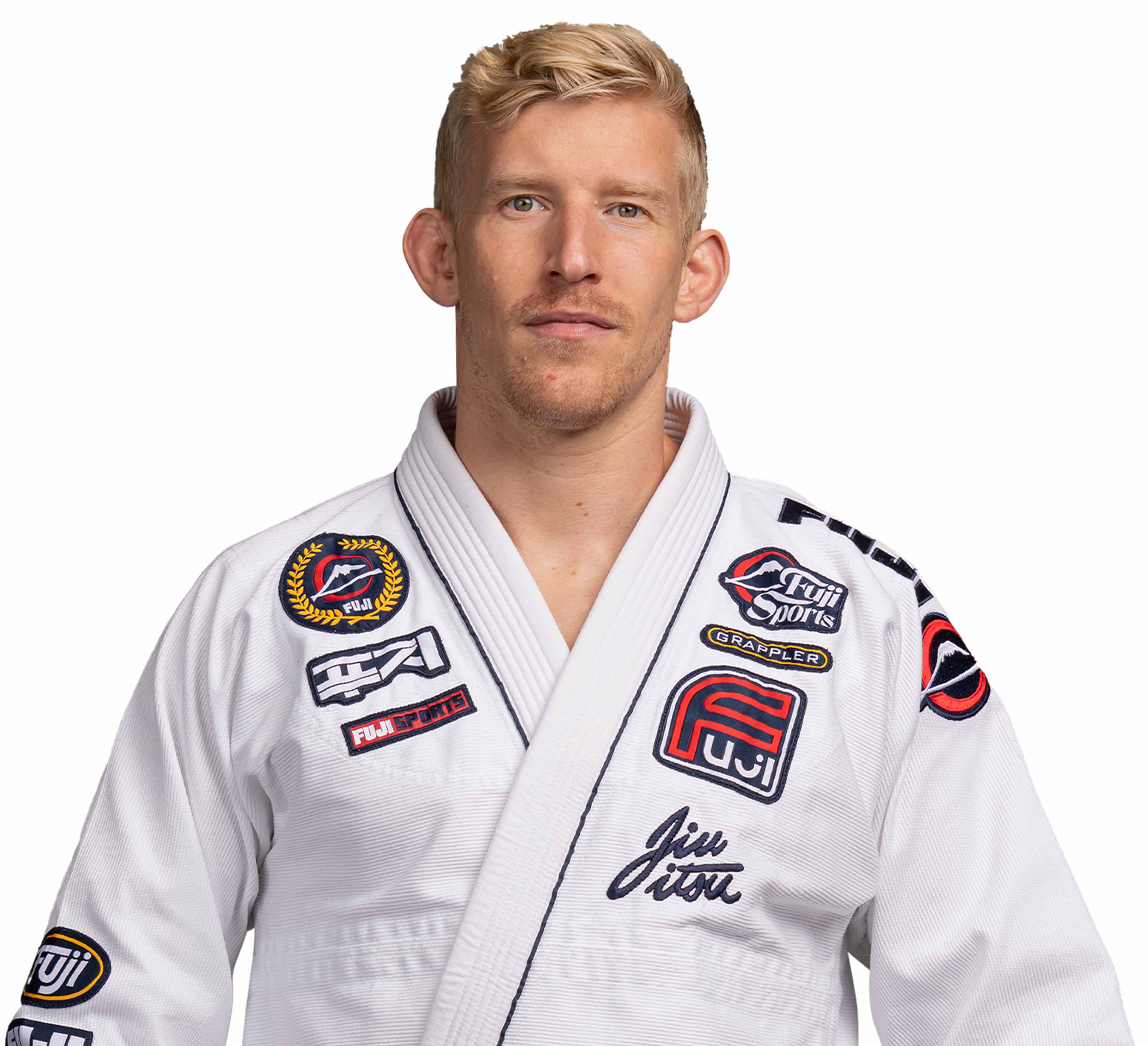 A man with short blond hair wears the Suparaito BJJ Gi XTR Edition White, decorated with patches, and stands against a plain white background, looking directly at the camera with a neutral expression.