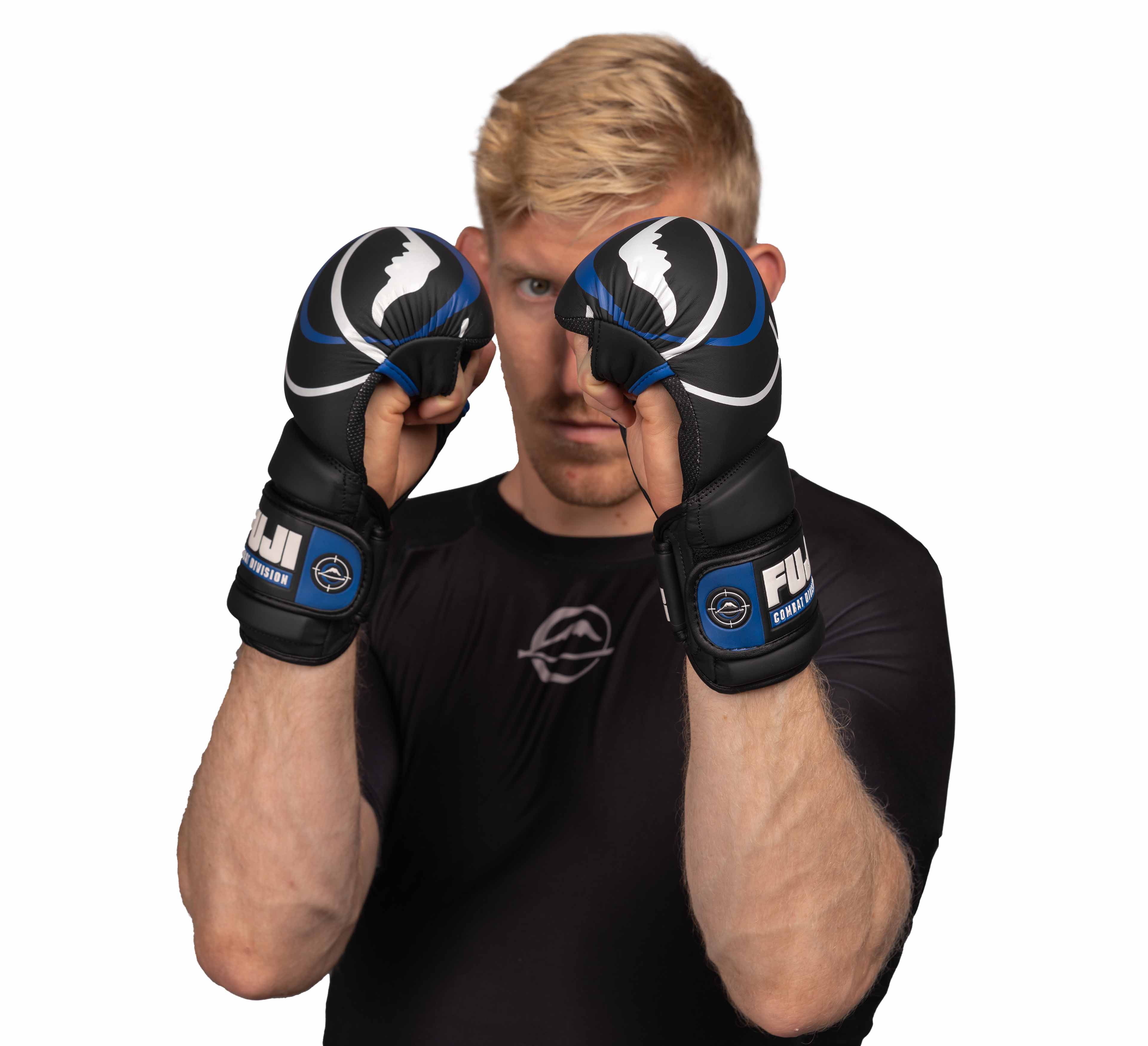 A blond-haired person in a black shirt wears Precision Striking Hybrid MMA Gloves, holding their fists up in a fighting stance and looking forward against a white background.