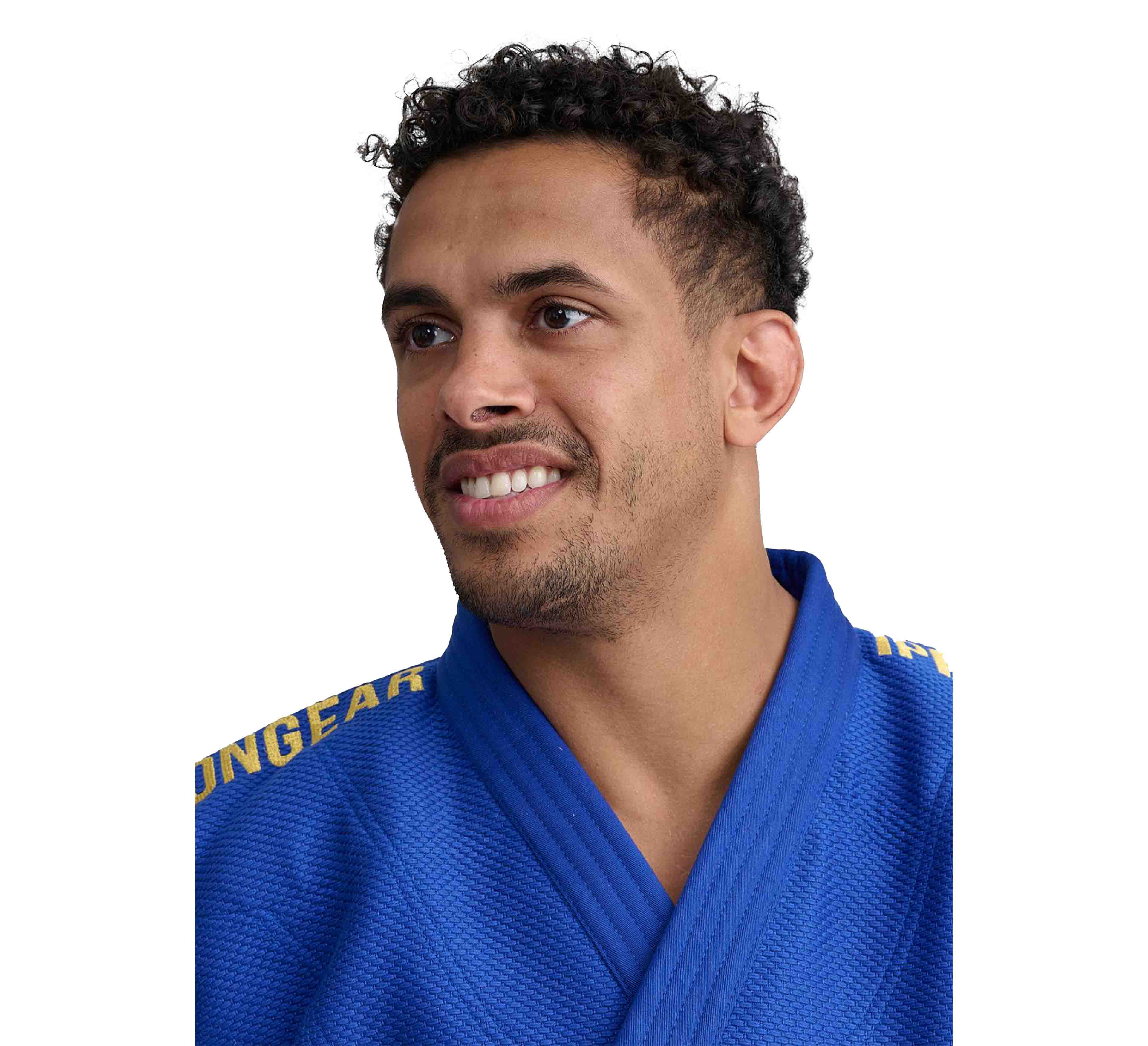 A man with short curly hair and a trimmed beard is smiling, wearing the Ippon Gear IJF Legends 2 Slim Fit Blue (Jacket Only) with yellow writing on the shoulders, against a white background.