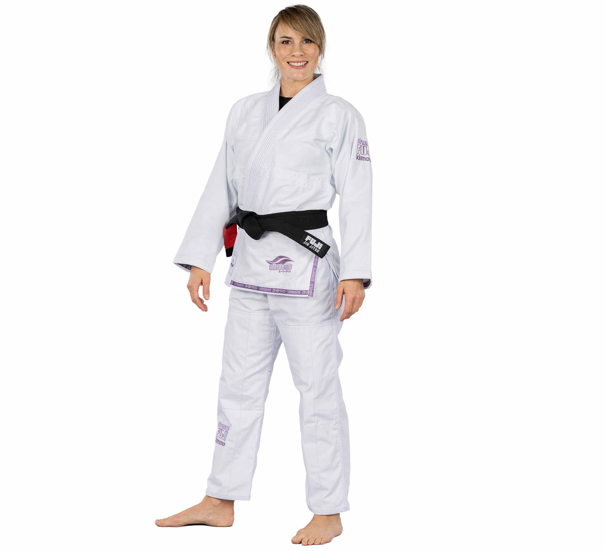 A person wearing the Suparaito Womens BJJ Gi in purple smiles while standing barefoot with a black belt, set against a plain white background.