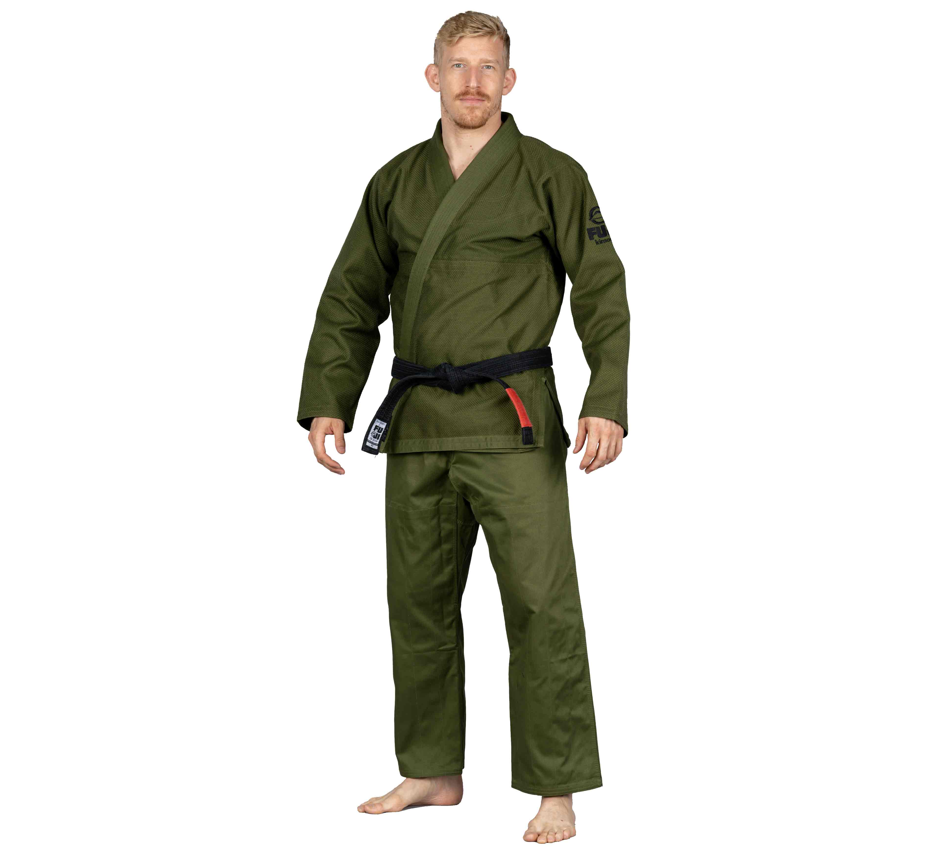 A man stands barefoot, wearing the All Around BJJ Gi Military Green with a black belt, facing forward with a neutral expression against a white background.