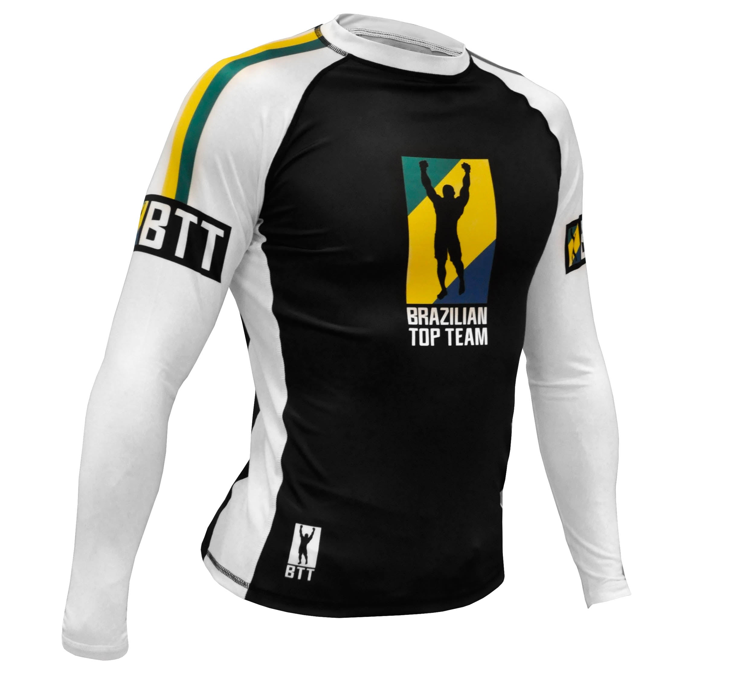 The BTT Ranked Long Sleeve Womens Rashguard features a black front, white sleeves, and a yellow-blue logo with a raised-arm figure. “BRAZILIAN TOP TEAM” appears on the chest and “BTT” is printed on the sleeves.