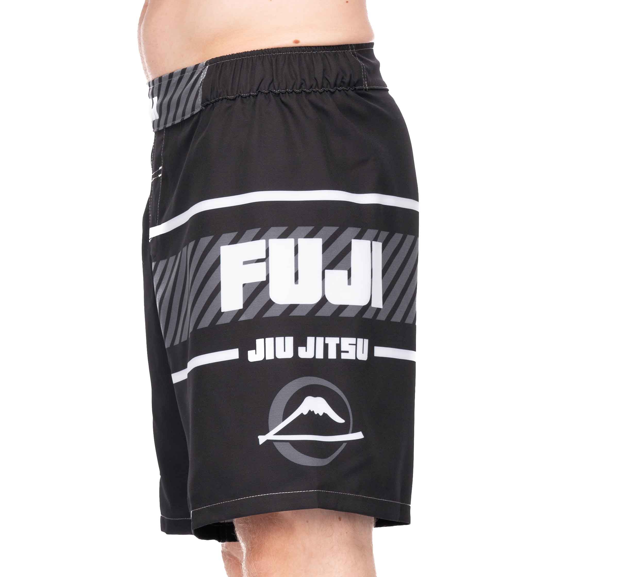 A person wearing Freestyle 2.0 Ranked Grappling Shorts in black, featuring the FUJI JIU JITSU name and a mountain logo on the side. Only their lower torso and upper legs are shown against a white background.