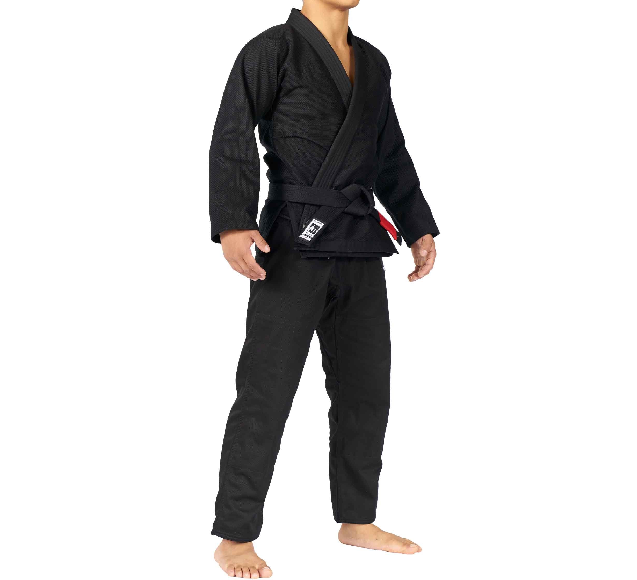 A person wearing the All Around BJJ Gi and a black belt stands barefoot on a white background, arms relaxed at their sides, with their head not visible.