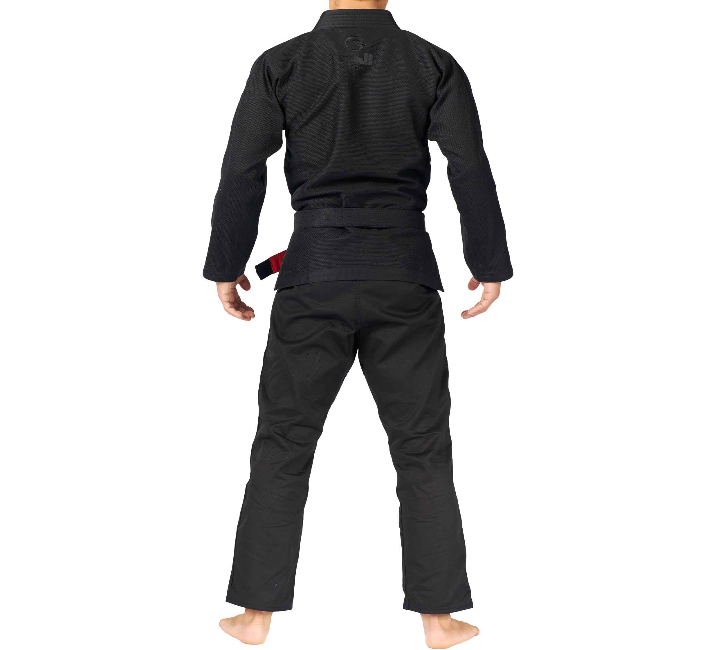 Person stands barefoot, facing away from the camera, wearing the All Around BJJ Gi with a black belt, set against a plain white background.