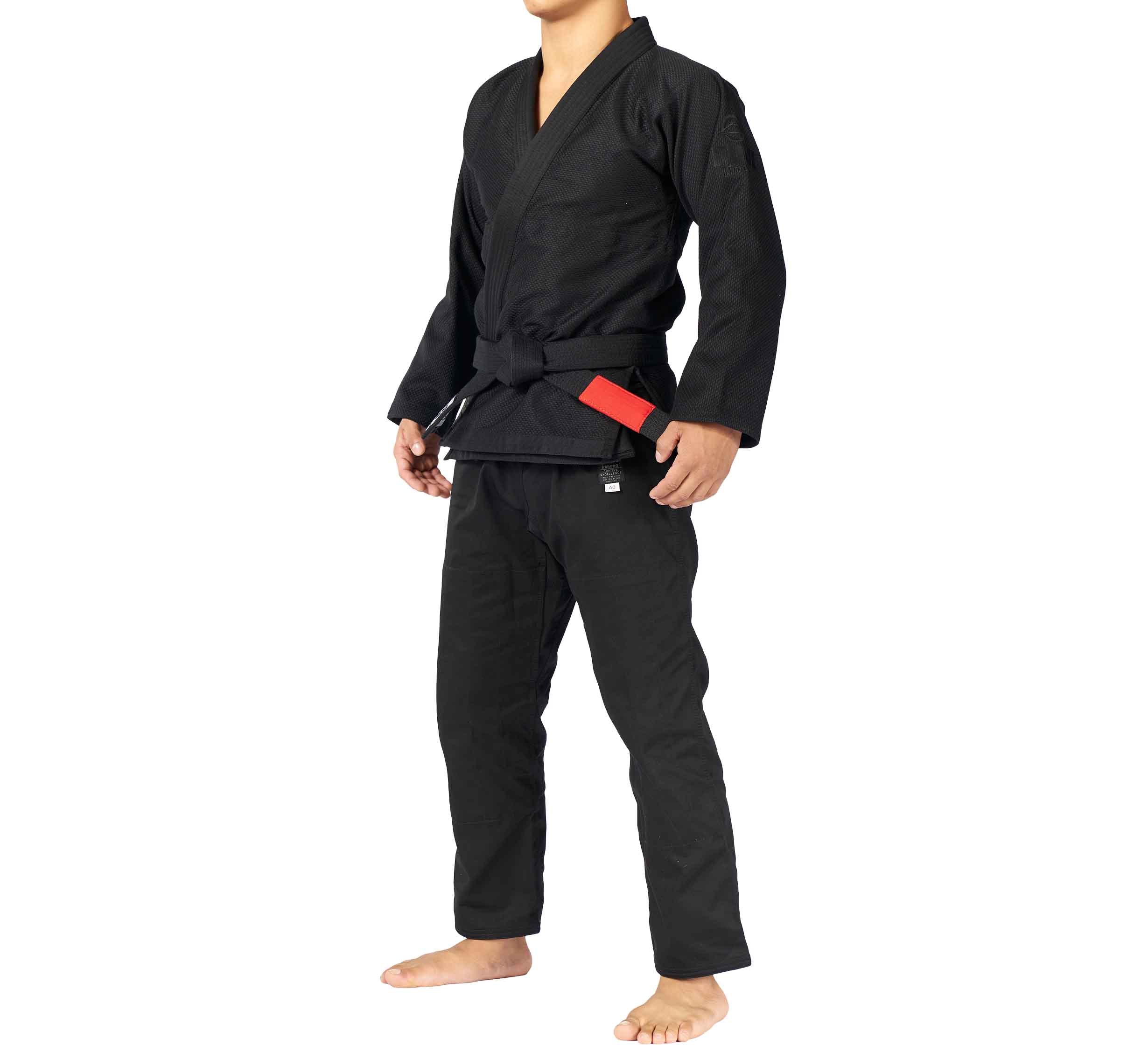 A person wearing the All Around BJJ Gi with a black belt stands barefoot facing slightly to the side, against a plain white background.