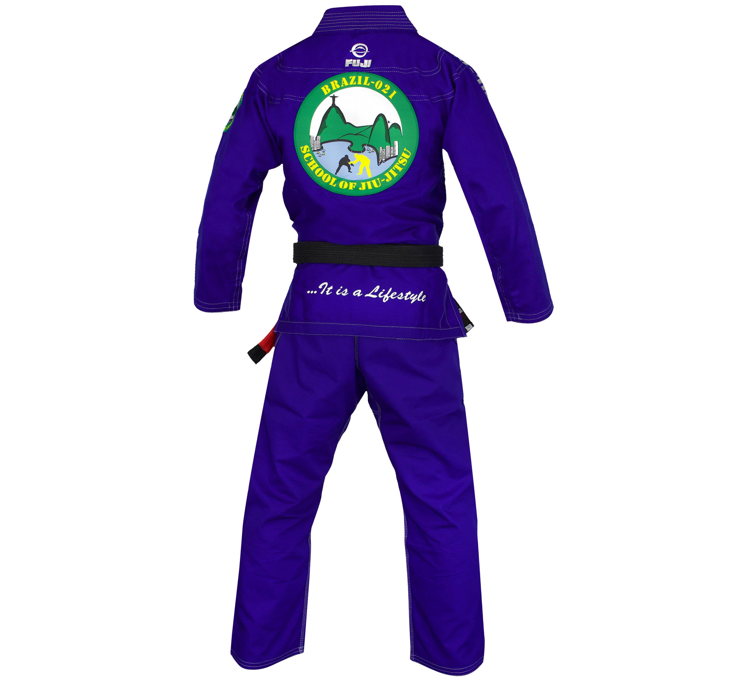 The Brazil 021 Competition Gi in blue is shown from the back, displaying a school logo with a mountain, sun, and two fighters. It features a black belt and “…It is a Lifestyle” written at the lower back.