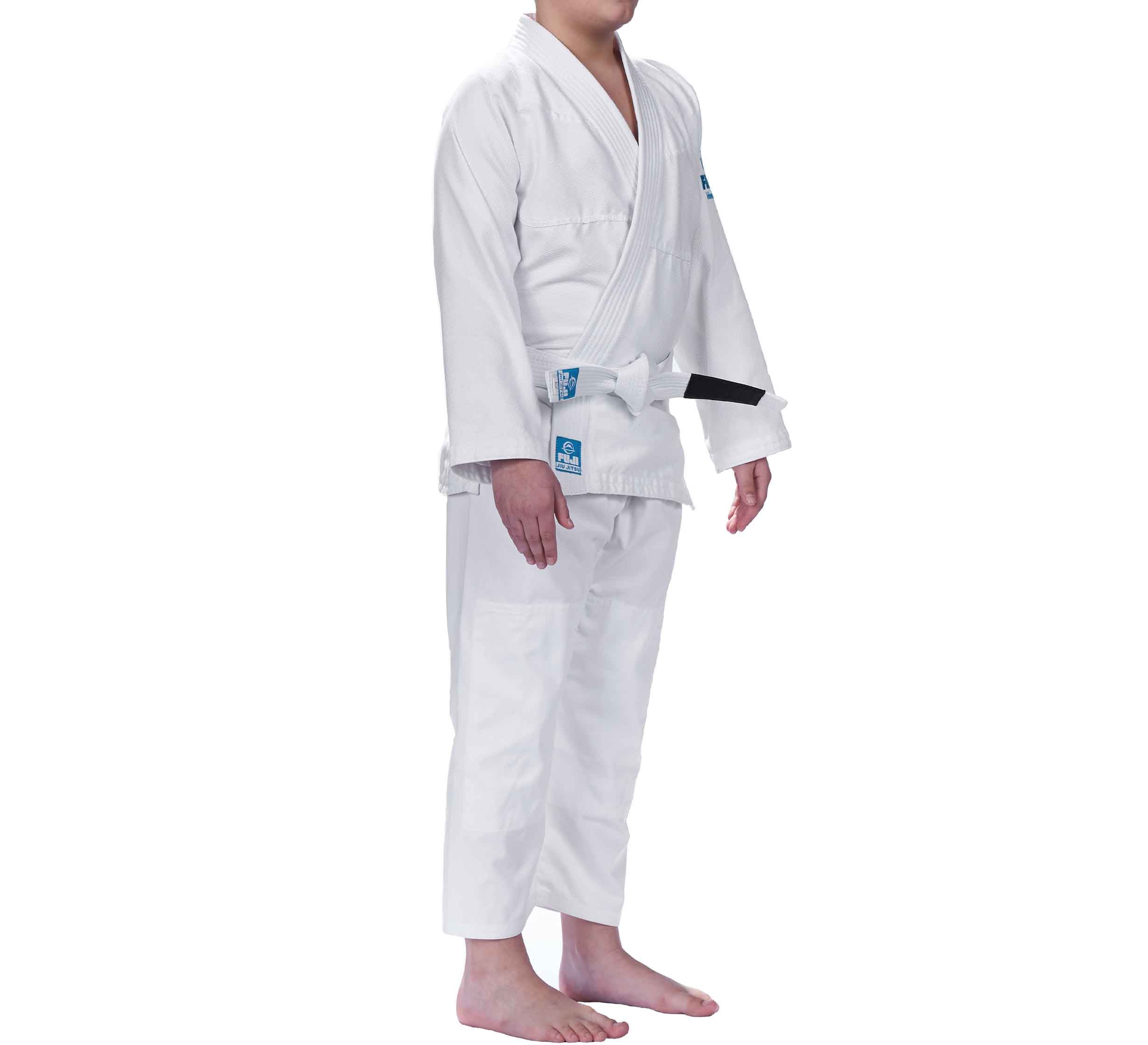 A barefoot child in side view wears the Starter Kids BJJ Gi White with a white belt featuring a black stripe, set against a plain white background.