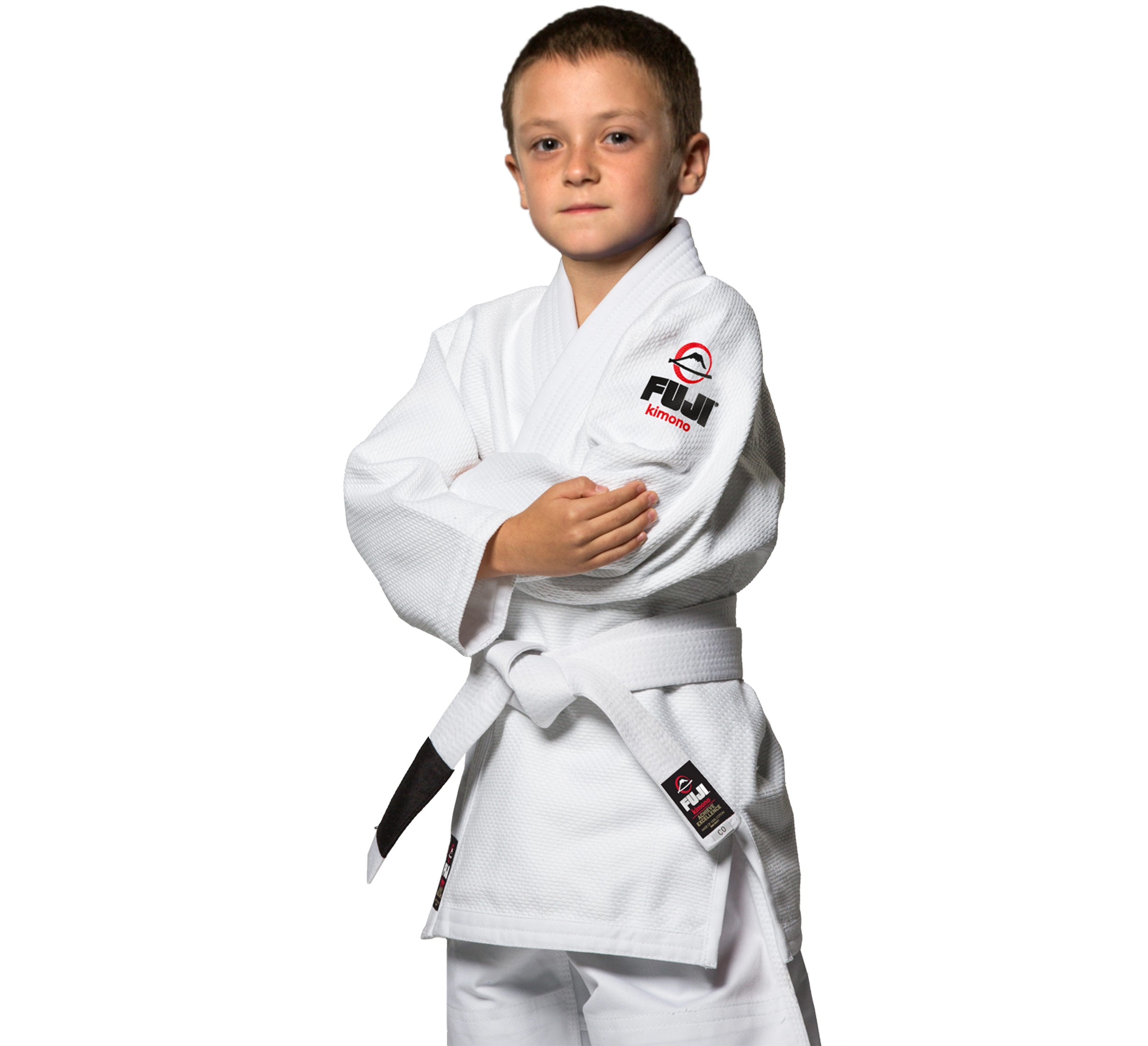 A young boy stands confidently with arms crossed, wearing the All Around Kids BJJ Gi White with a white belt, looking at the camera against a plain white background.