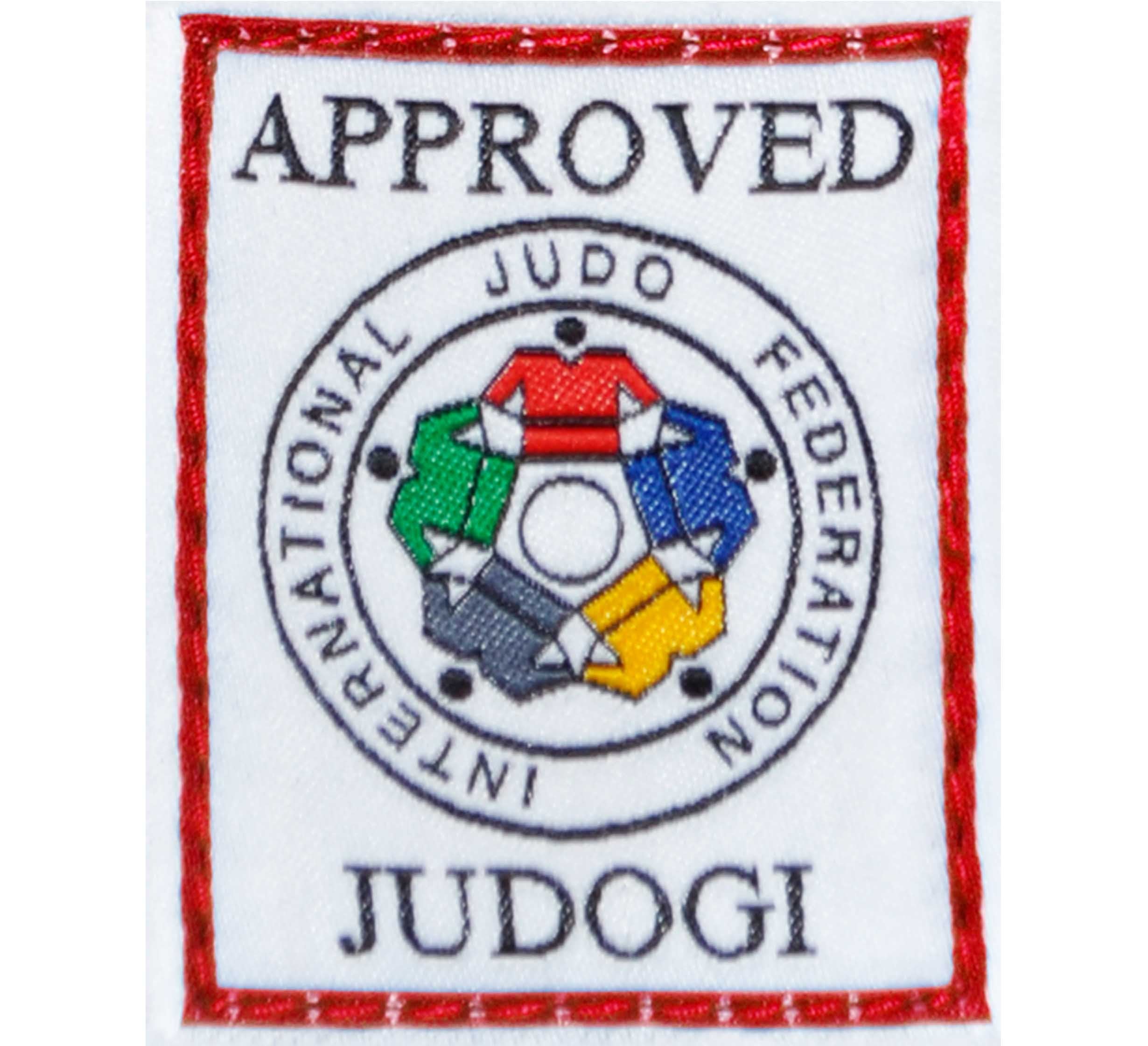 Rectangular patch with a red border on the Mizuno Yusho Comp Judo Gi White, showing “APPROVED JUDOGI” and the International Judo Federation’s circular logo with five interlocking colorful shapes in the center.