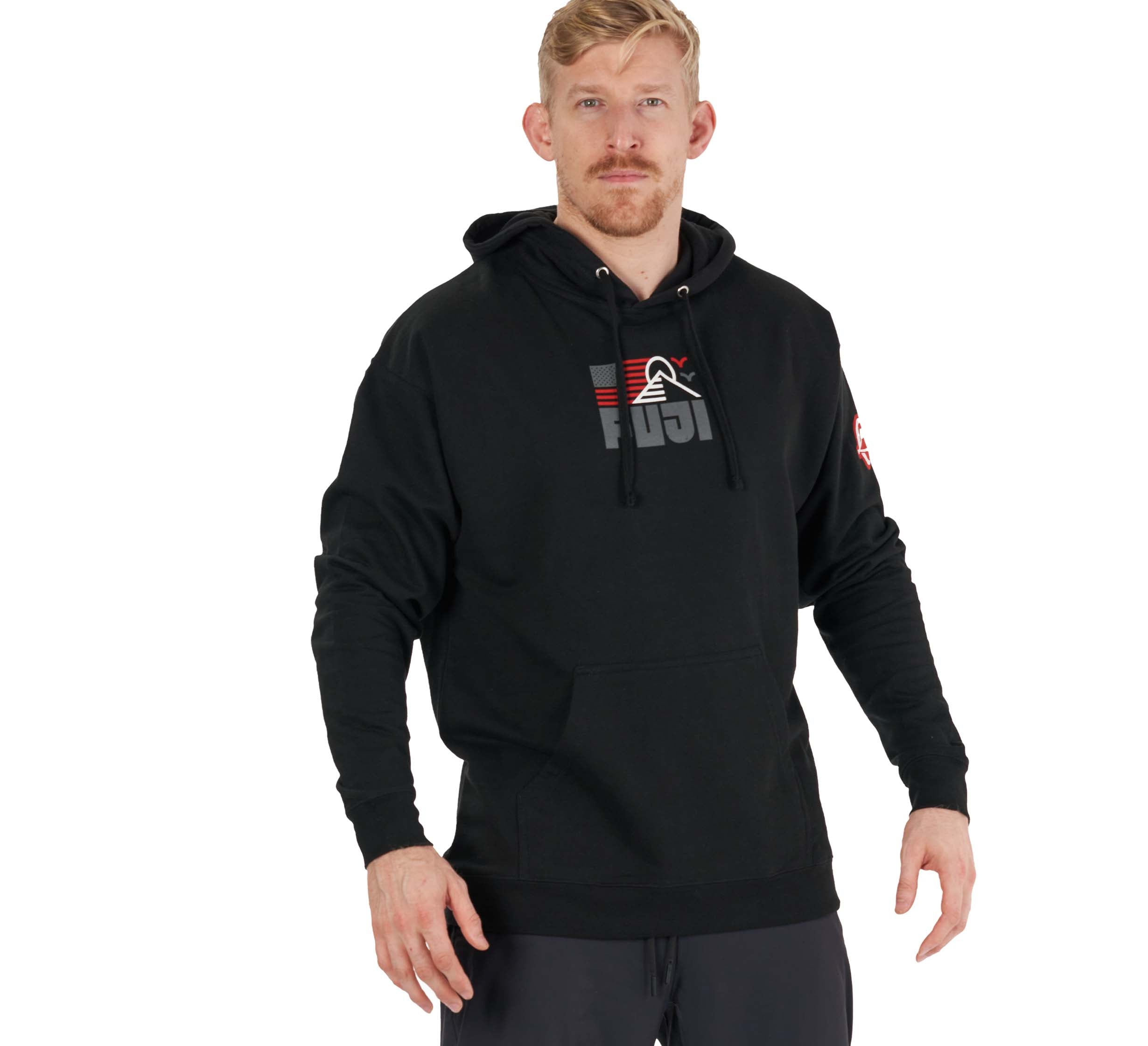 A man with short blonde hair and a beard wears the Achieve Hoodie Black, featuring a red, gray, and white graphic design on the chest, standing against a plain white background.