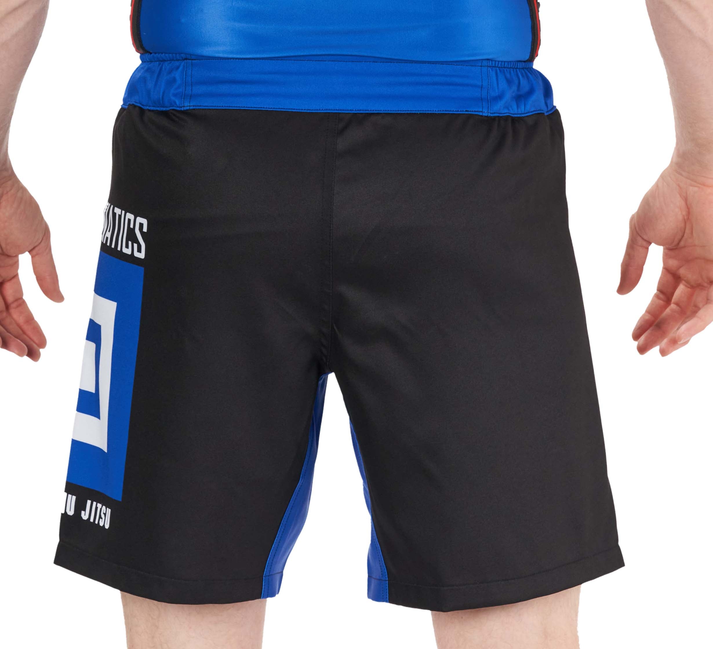 Someone is shown from the back wearing BJJ Fanatics Lightweight Shorts Blue, featuring a black and blue geometric design with text on the left side, standing with their hands by their sides.