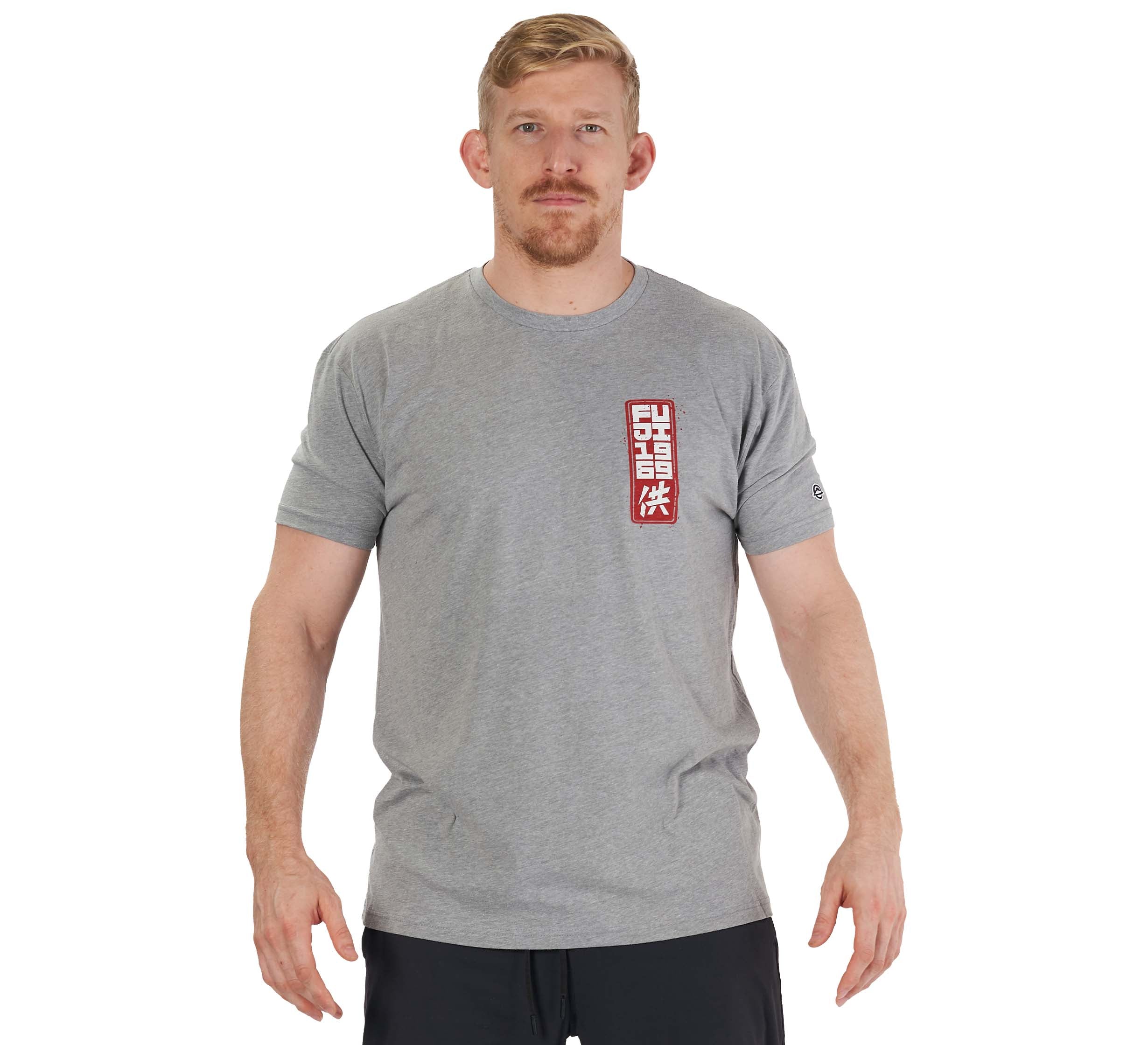 A man with short blonde hair and a beard wears the Prepare For Battle T-Shirt in heather grey, featuring a red and white rectangular graphic on the left chest. He stands facing forward with arms relaxed against a white background.