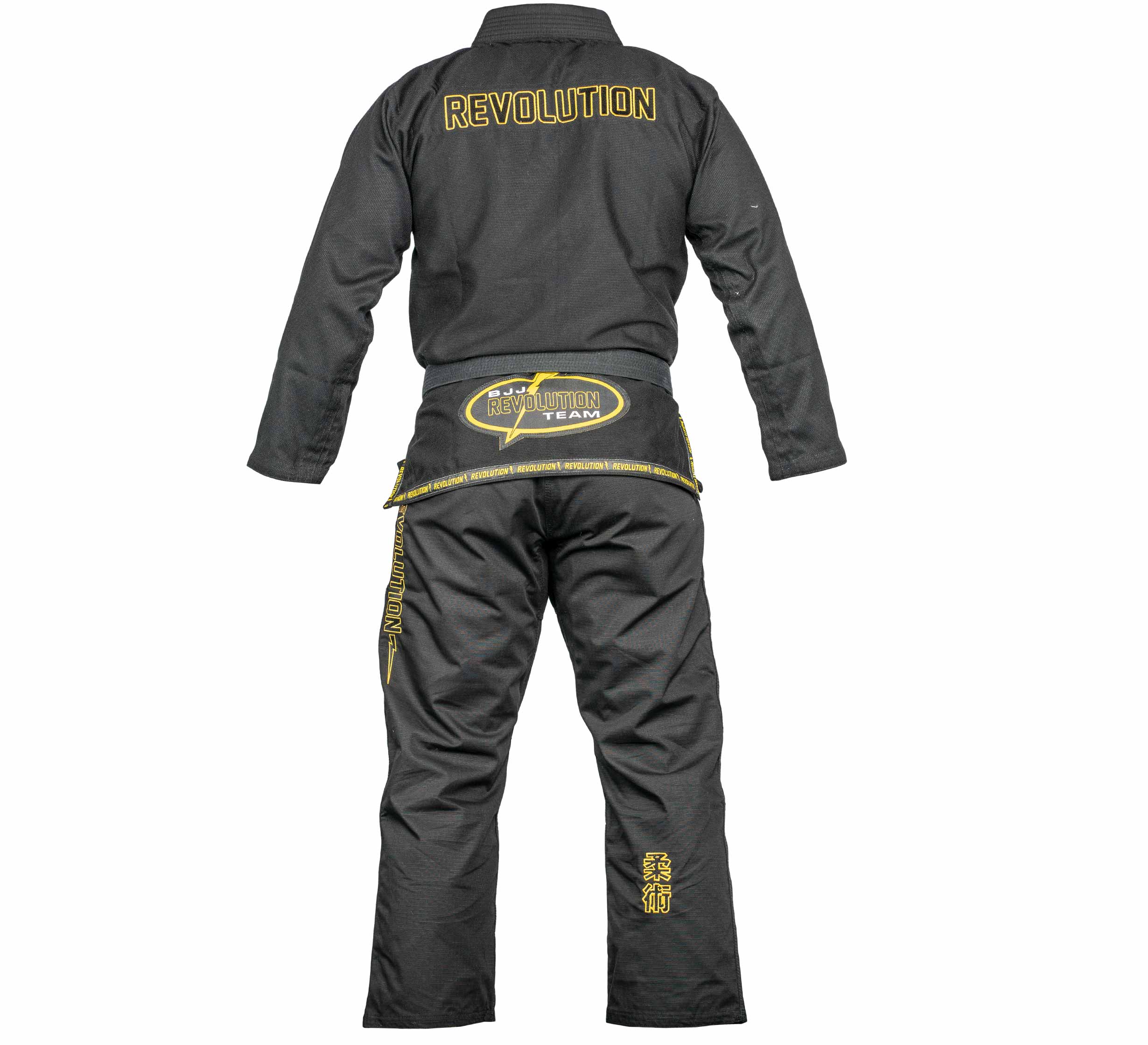 The BJJ Revolution Super Lite Kids Gi (Black) is shown from the back, with yellow embroidered "REVOLUTION" on the jacket and yellow patches and lettering on the pants and waistband.