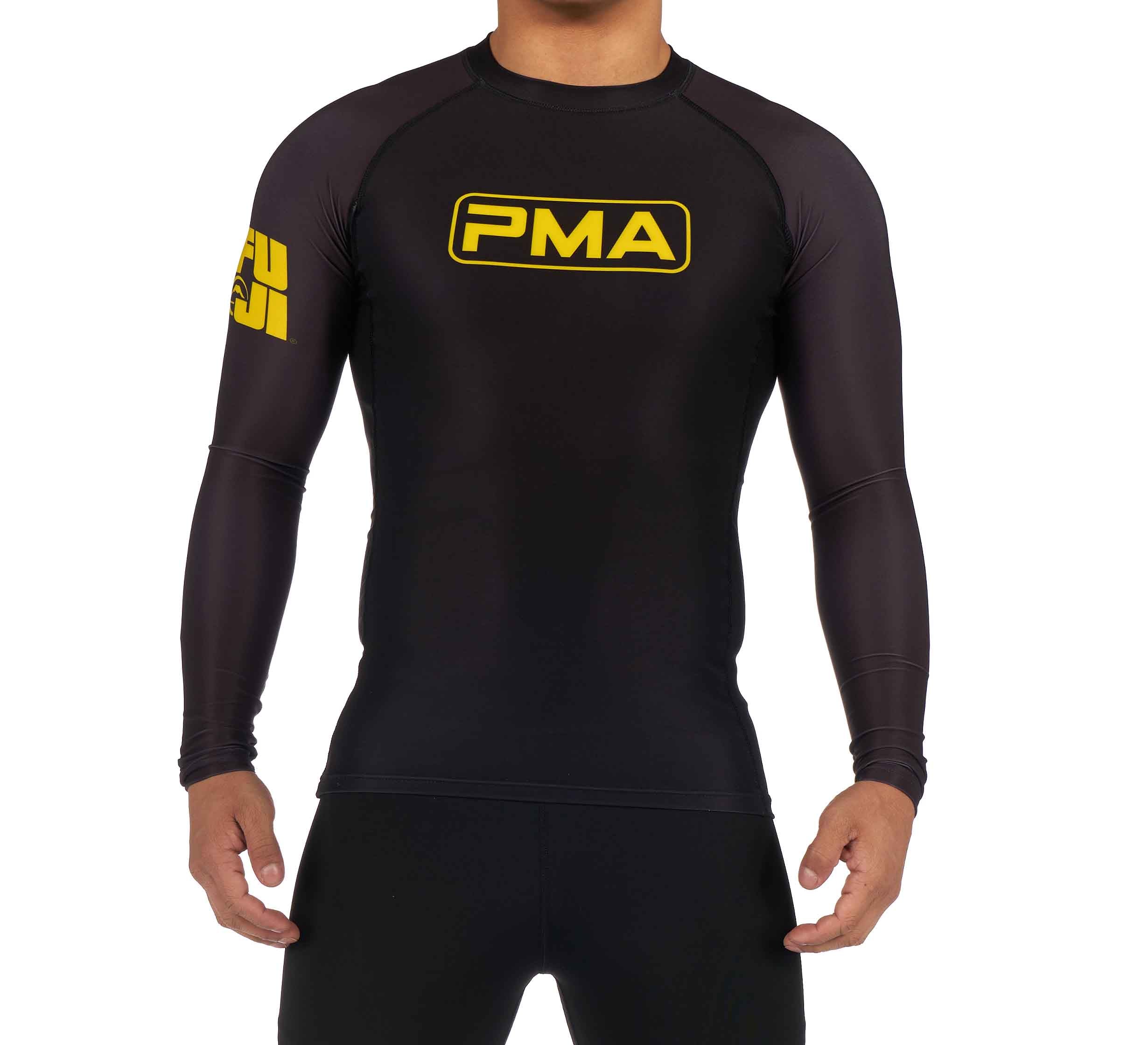 A person wearing the Premier Martial Arts Long Sleeve Rashguard, black with "PMA" in yellow on the chest and a yellow logo on the left upper arm, stands against a plain white background.