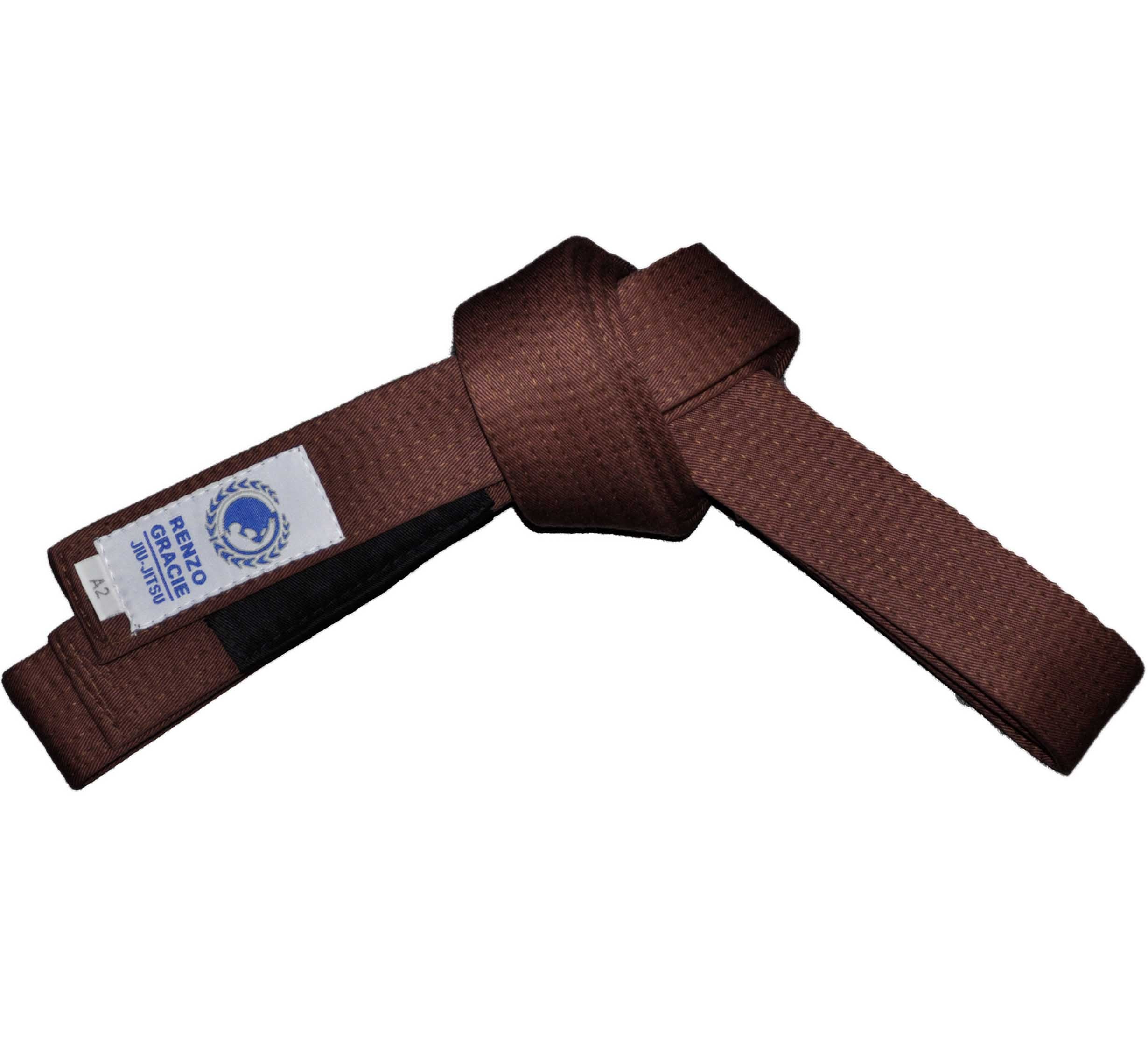 The Renzo Gracie BJJ Belt Brown features a textured brown surface and a white patch with a logo and "Brazilian Jiu-Jitsu," neatly folded against a white background.