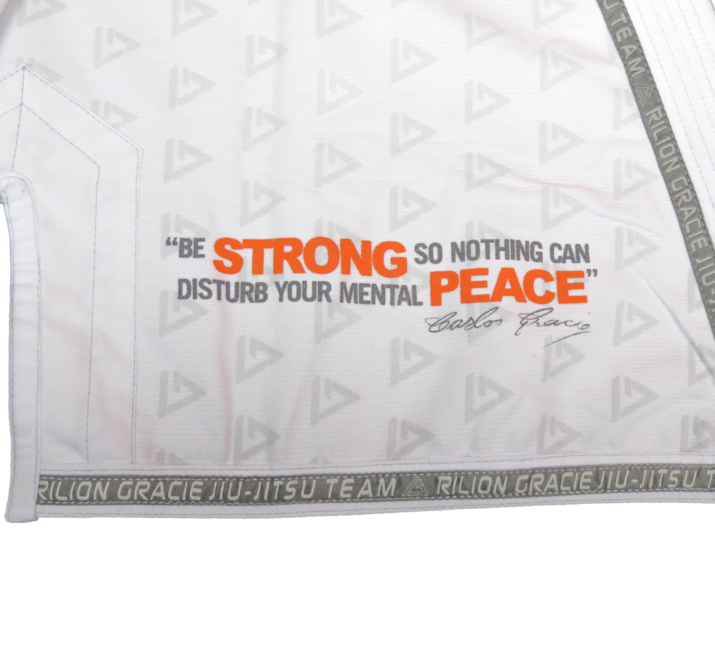 The Rilion Gracie Superlite Gi is a white martial arts uniform with “Be strong so nothing can disturb your mental peace” and a signature, featuring patterned lining and “Rilion Gracie Jiu-Jitsu Team” trim.