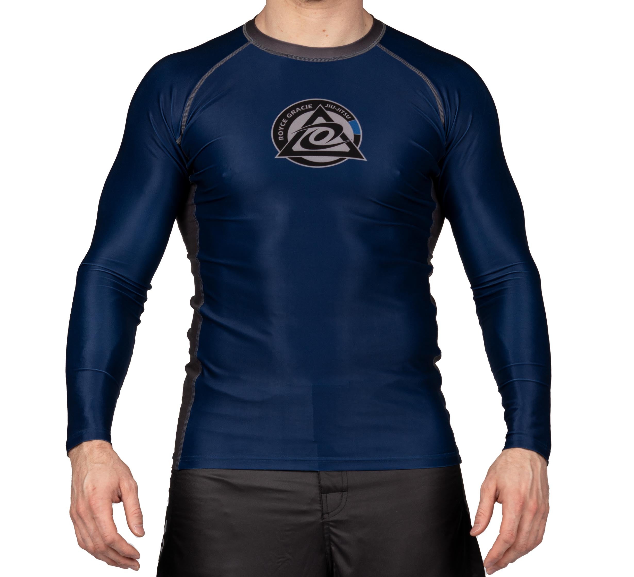 A person wearing the Royce Gracie Official Long Sleeve Rashguard in navy blue with a circular martial arts academy logo on the chest and black athletic shorts. Their head is not visible.