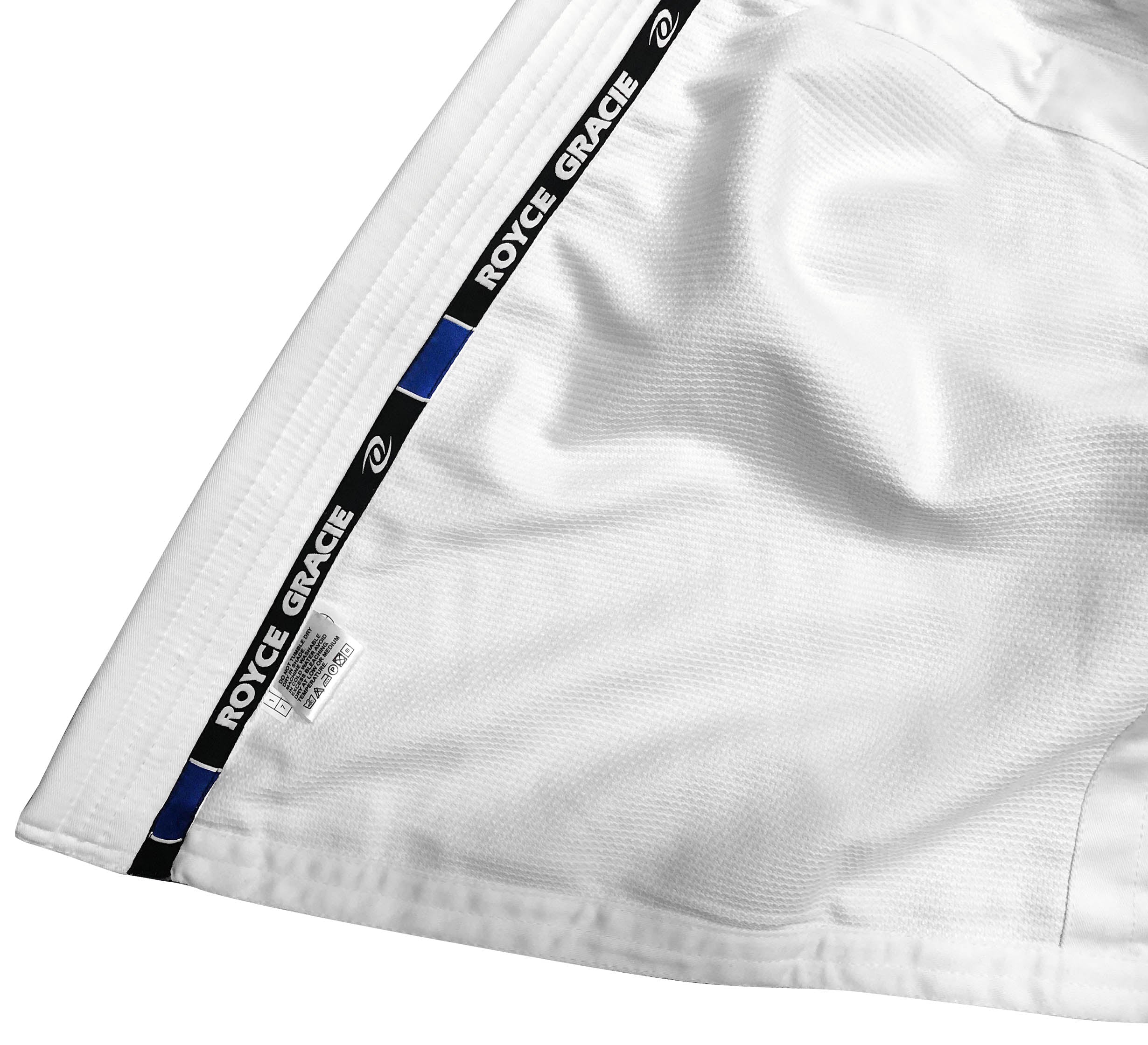 Close-up of the Royce Gracie Original Pro Series Gi, featuring a white design and ROYCE GRACIE branding on a black and blue strip along the side seam.