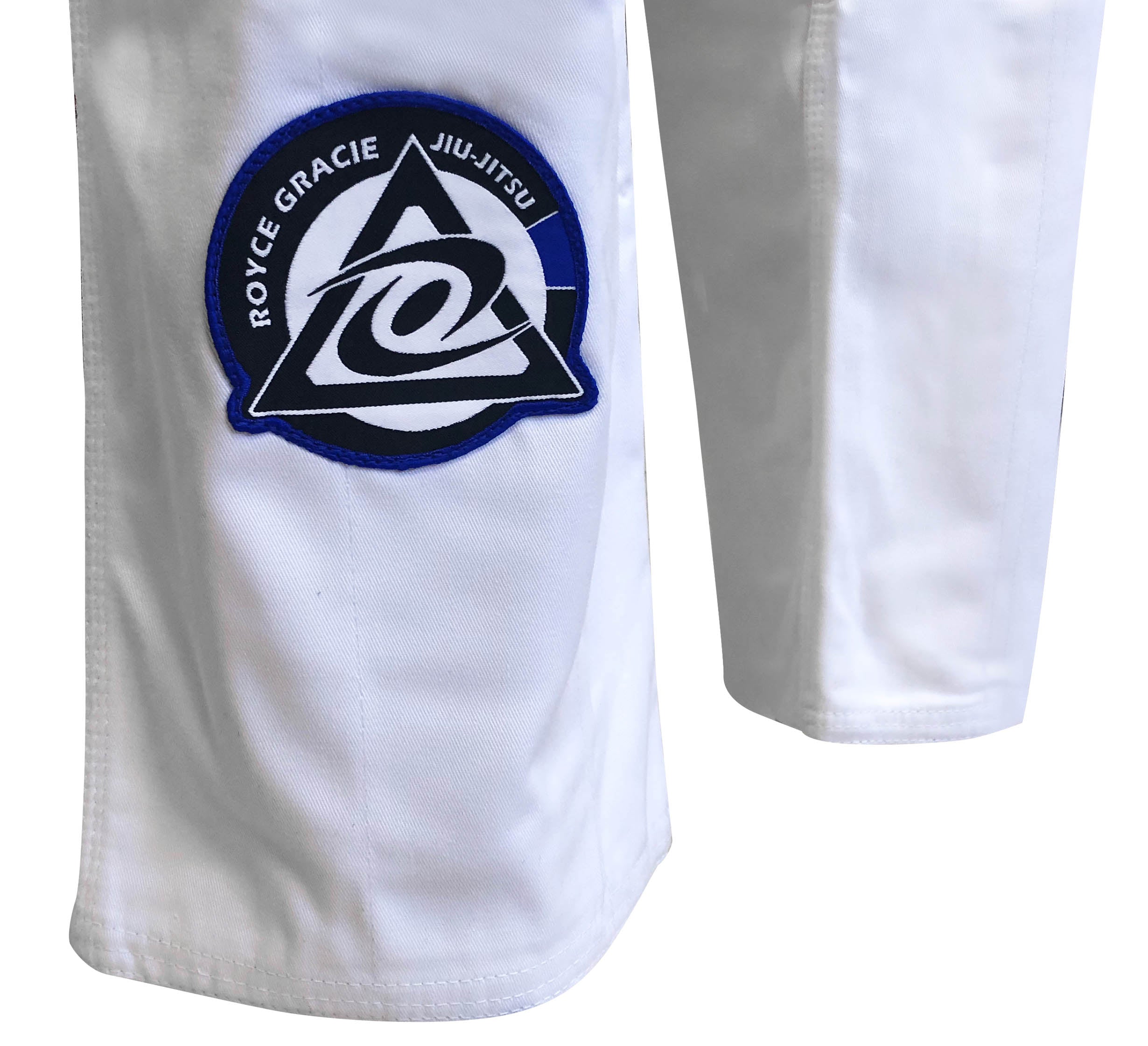 Close-up of the Royce Gracie Original Pro Series Gi, featuring a patch with "Royce Gracie Jiu-Jitsu" and a blue, black, and white triangular logo on the pant leg.
