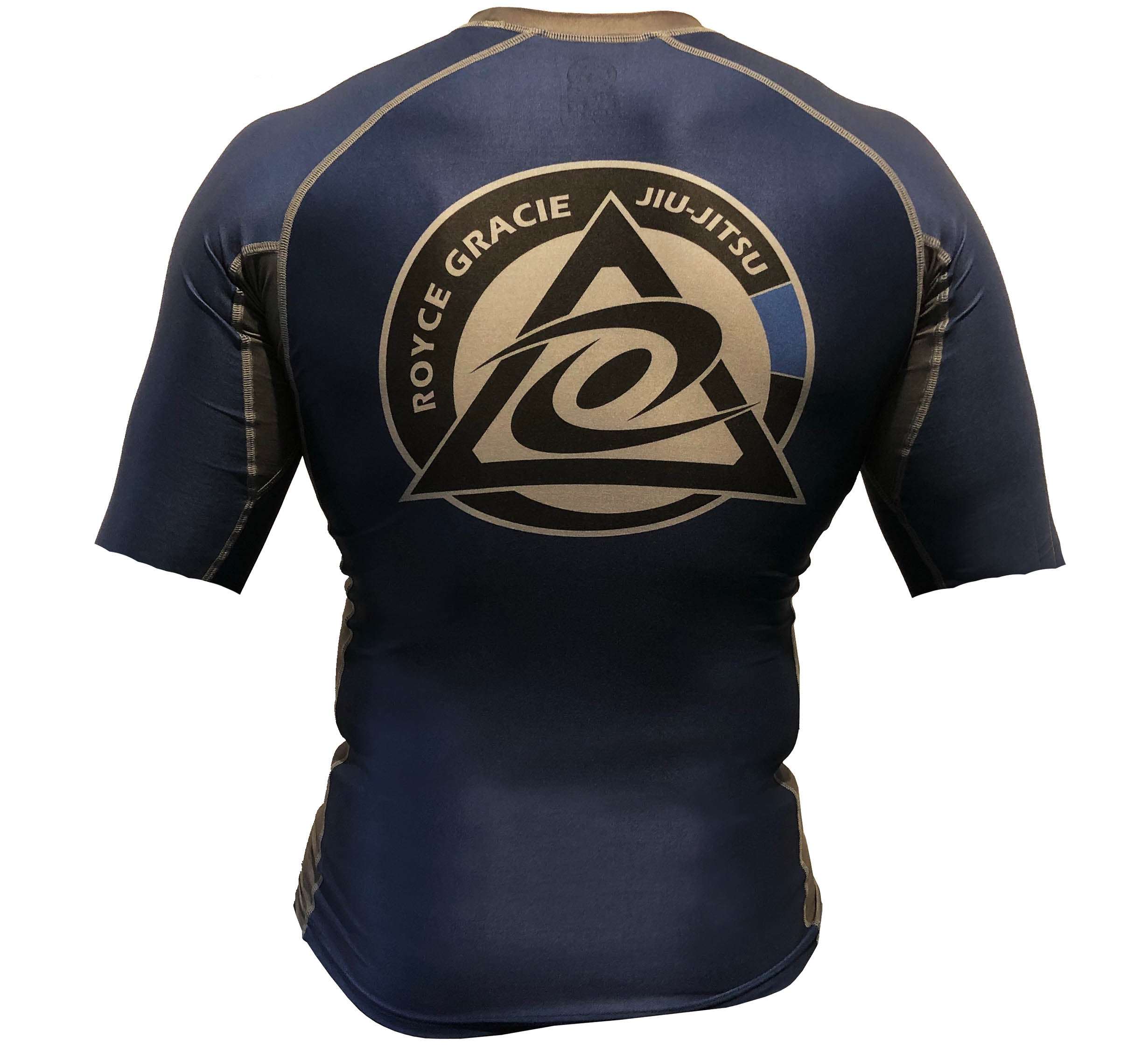 The Royce Gracie Short Sleeve Rashguard is shown from the back in black and gold, featuring a large triangular Jiu-Jitsu logo and a bold central design.